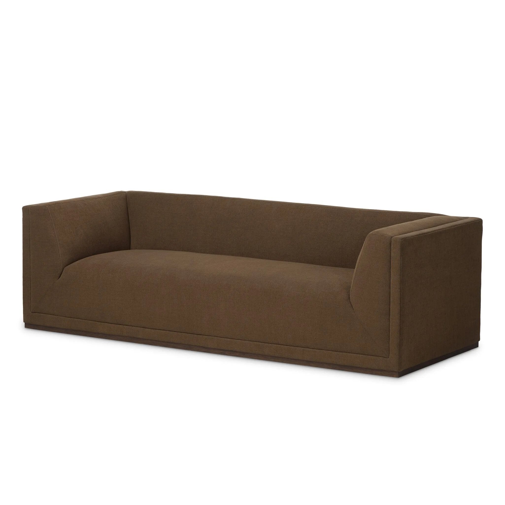 An inviting take on the classic tuxedo sofa, made for modern living. Celebrating mitered corners, for precision at every angle, and a layered, upholstered frame for a sharp, architectural look, the sofa rests on a wood plinth base. Tailored in the United States with thick pocket-seam cushions for unexpected comfort. Amethyst Home provides interior design, new home construction design consulting, vintage area rugs, and lighting in the Charlotte metro area.