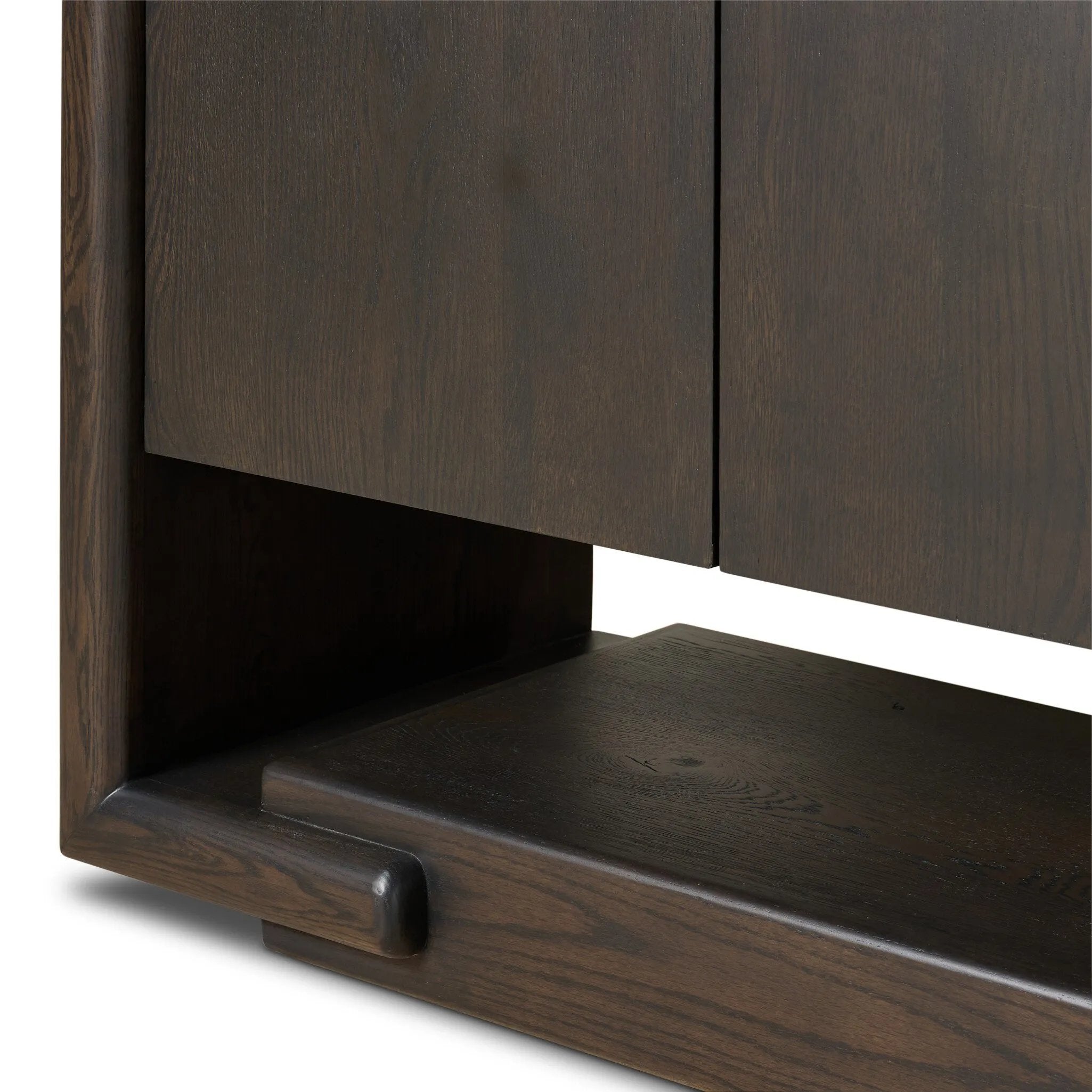 Store favorite table linens and serveware in an oak sideboard with a unique float-like appearance. A thick base doubles as bonus shelving, with inserted waterfall framing lifting up the full case. Finished in a smoked black to showcase gorgeous wood character. Amethyst Home provides interior design, new home construction design consulting, vintage area rugs, and lighting in the Newport Beach metro area.