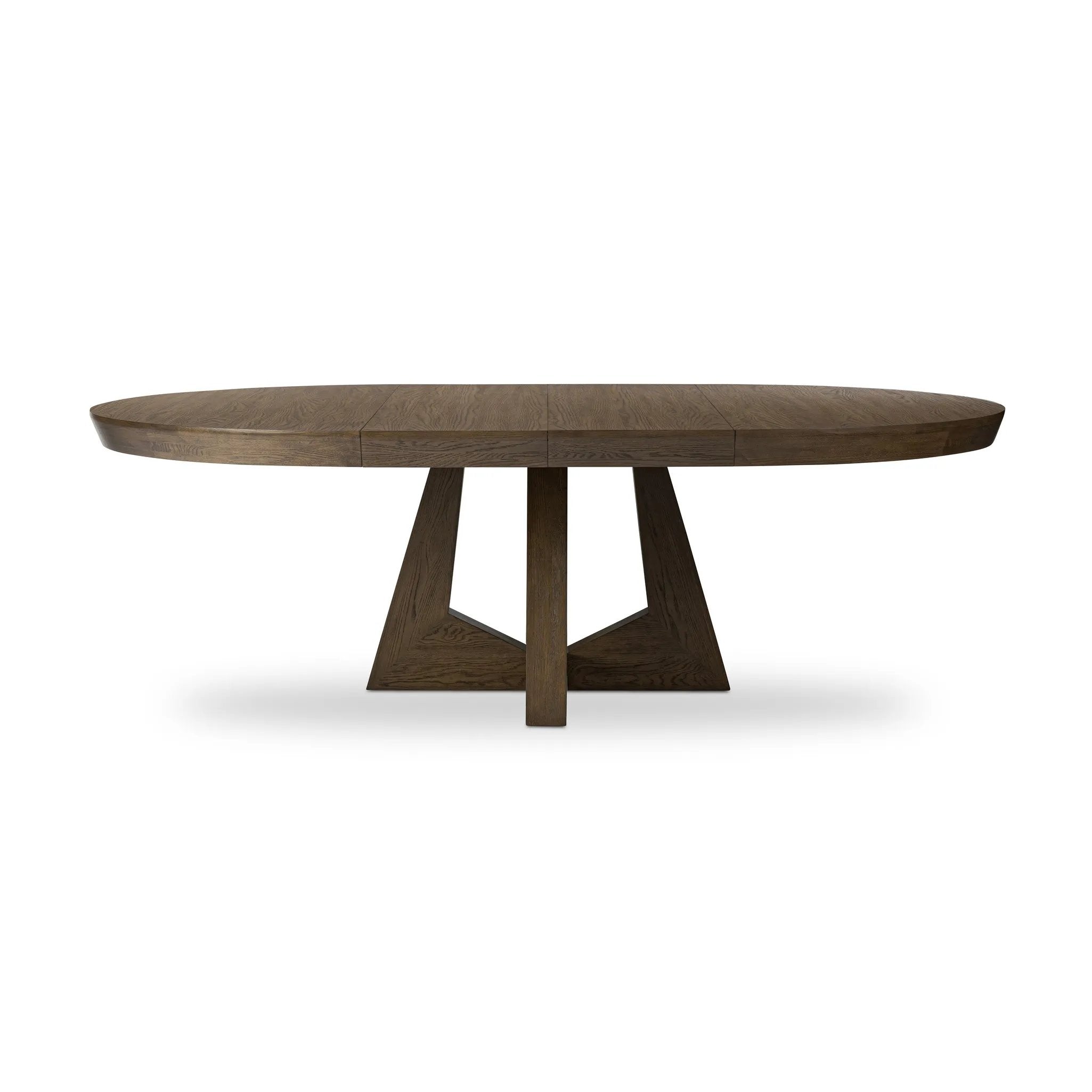 Sculptural angles define this expansive oak dining table, as angled cutouts play up a tapered base and top. Expandable design includes two leaves, easily extending from 77" to 94", for intimate gatherings and dinner parties alike Amethyst Home provides interior design, new home construction design consulting, vintage area rugs, and lighting in the Charlotte metro area.