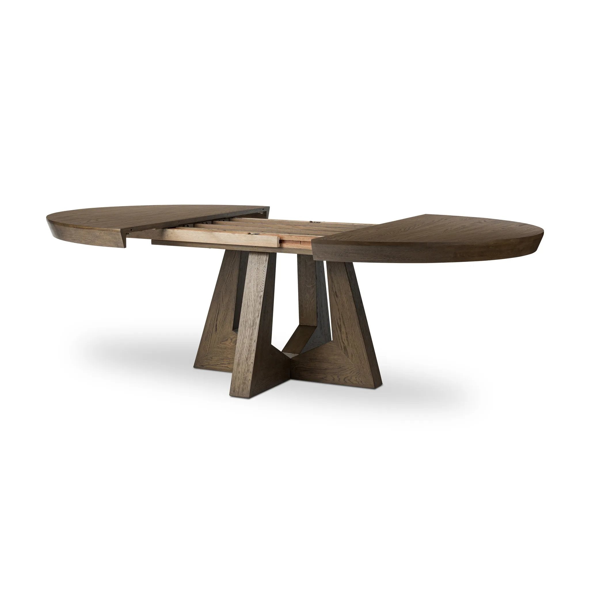 Sculptural angles define this expansive oak dining table, as angled cutouts play up a tapered base and top. Expandable design includes two leaves, easily extending from 77" to 94", for intimate gatherings and dinner parties alike Amethyst Home provides interior design, new home construction design consulting, vintage area rugs, and lighting in the San Diego metro area.