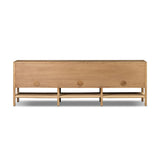 Simple yet refined, a Danish design-influenced sideboard is made from light-finished ash, with iron hardware finished in a sleek gunmetal. Perfect for larger spaces, with six doors and generous interior storage. Stretcher-style shelving made from woven paper cord serves up a textural finishing touch. Amethyst Home provides interior design, new home construction design consulting, vintage area rugs, and lighting in the Dallas metro area.