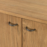 Simple yet refined, a Danish design-influenced sideboard is made from light-finished ash, with iron hardware finished in a sleek gunmetal. Perfect for larger spaces, with six doors and generous interior storage. Stretcher-style shelving made from woven paper cord serves up a textural finishing touch. Amethyst Home provides interior design, new home construction design consulting, vintage area rugs, and lighting in the Newport Beach metro area.