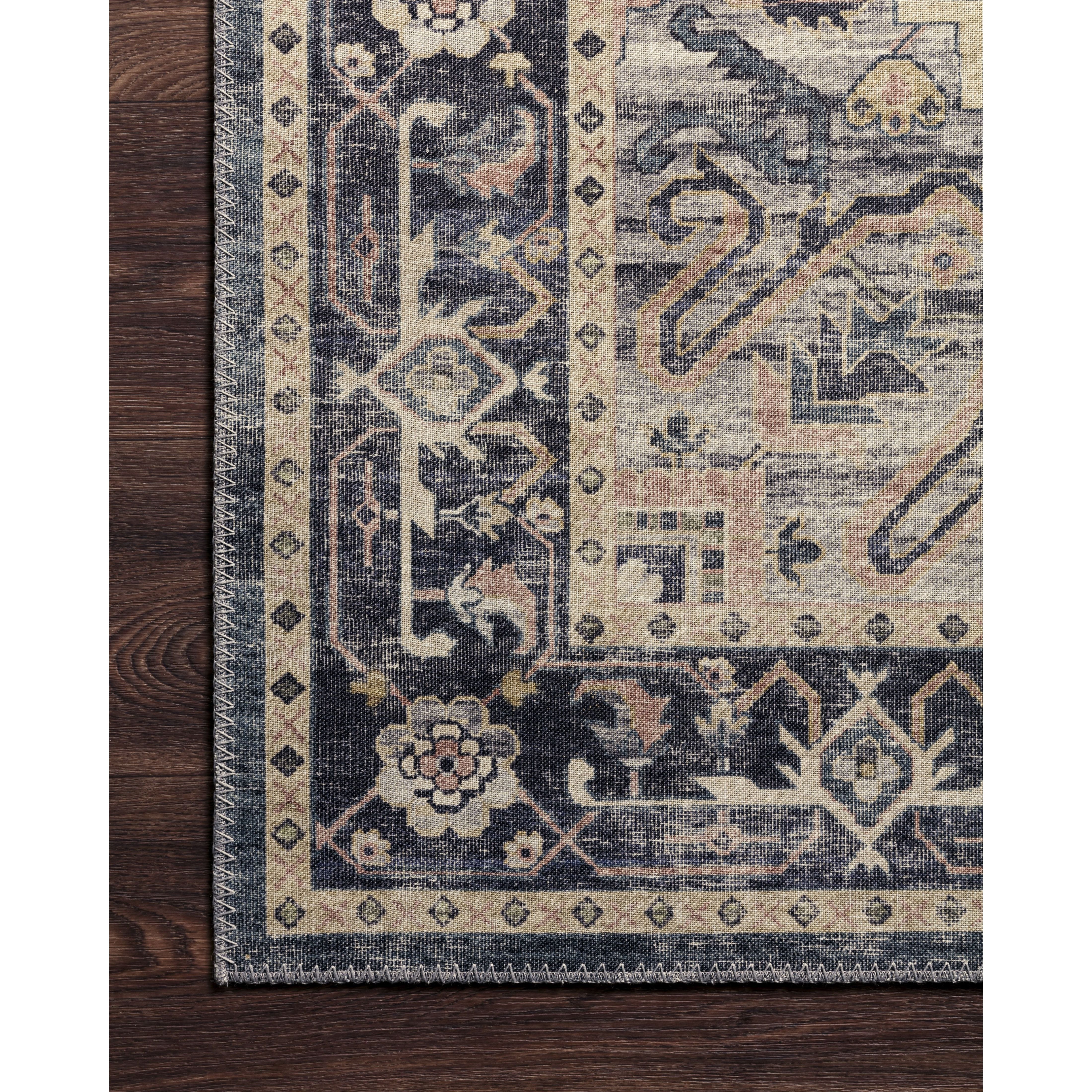 Featuring soft motifs in a carefully curated color palate of black, blue, yellow, and hints of orange, the Hathaway Navy / Multi area rug captures the essence of one-of-a-kind vintage or antique area rug. This rug is ideal for high traffic areas such as living rooms, dining rooms, kitchens, hallways, and entryways.