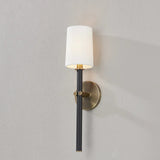A traditional design with modern detailing, Belvedere is defined by its uniquely held candlesticks. Each Patina Brass arm on the ten-light chandelier holds two Texture Black candlesticks pierced through on opposing sides of the arm. The candlestick on the one-light wall sconce is pinched in place by two Patina Brass arms. Amethyst Home provides interior design, new home construction design consulting, vintage area rugs, and lighting in the Boston metro area.