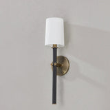 A traditional design with modern detailing, Belvedere is defined by its uniquely held candlesticks. Each Patina Brass arm on the ten-light chandelier holds two Texture Black candlesticks pierced through on opposing sides of the arm. The candlestick on the one-light wall sconce is pinched in place by two Patina Brass arms. Amethyst Home provides interior design, new home construction design consulting, vintage area rugs, and lighting in the Winter Garden metro area.