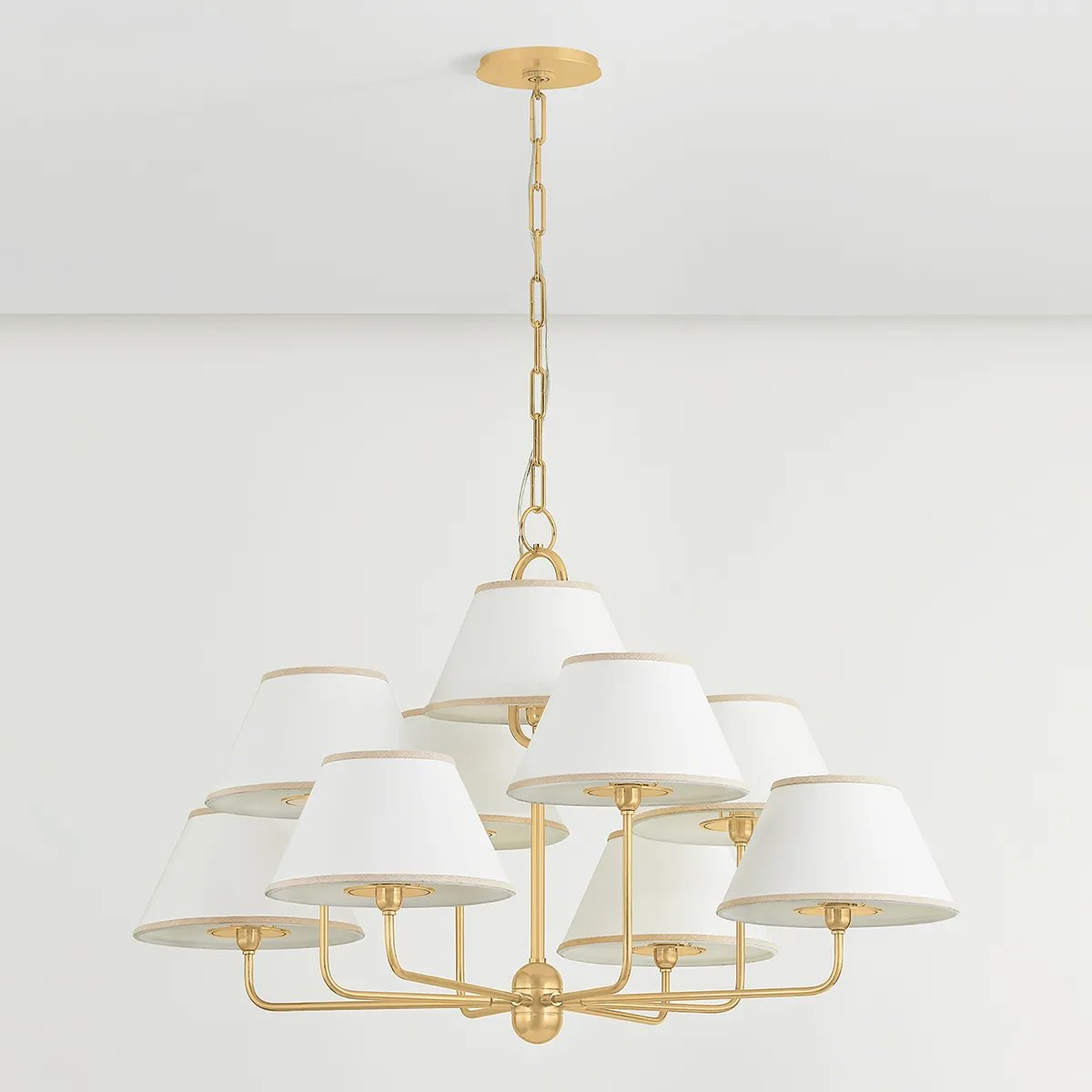 A vintage-inspired silhouette is elevated through thoughtful details in this transitional family. Arranged at varying heights, the overscale white linen tapered shades create a voluminous effect, like a sail billowing in the wind. Ivory trim provides subtle visual interest while remaining fresh and neutral. Amethyst Home provides interior design, new home construction design consulting, vintage area rugs, and lighting in the Houston metro area.