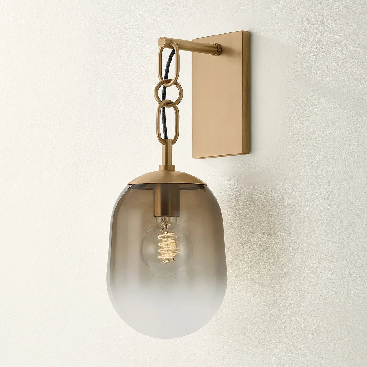 The Harvey chandelier’s dangling arms and artistic ombre glass are both Calderesque and faintly organic. Softly pill-shaped Dark Bronze glass shades drip from racetrack-shaped links on the sparse, arcing metal framework. The subtle industrial details provide a striking contrast to the otherwise playful silhouette. Amethyst Home provides interior design, new home construction design consulting, vintage area rugs, and lighting in the Laguna Beach metro area.