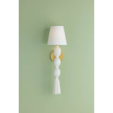 A celebration of authentic handicraft, the cinched silhouette of Indra resembles an elongated tassel. The cotton string and white linen shade create an all-over light, fresh appearance, accented by Aged Brass hardware at the neck. This single-light sconce serves as an artistic piece for small spaces in need of a spruce. Amethyst Home provides interior design, new home construction design consulting, vintage area rugs, and lighting in the Des Moines metro area.