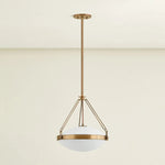 The Kade pendant updates a nostalgic shape with sleek, industrial metalwork and two large opal matte glass shades. Inspired by vintage elements, it features a striking suspension technique with three oversized loops connecting to the central housing above the fixture. The Patina Brass finish adds old-world finesse to the frame. Amethyst Home provides interior design, new home construction design consulting, vintage area rugs, and lighting in the Scottsdale metro area.