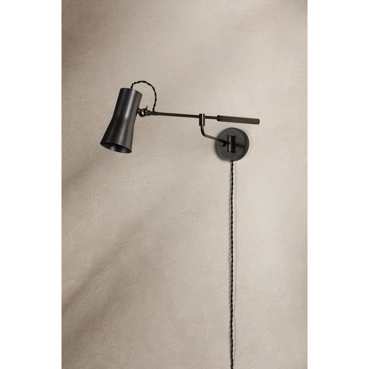Tailored task lighting, this portable, functional swing arm sconce is also thoughtfully designed and beautiful. The sleek arm features a wooden handle on one end and an adjustable metal shade in Patina Brass or Bronze on the other. The twisted black cord detailing at the shade and backplate give Novel a nostalgic feel. Amethyst Home provides interior design, new home construction design consulting, vintage area rugs, and lighting in the Boston metro area.