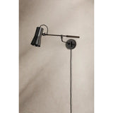 Tailored task lighting, this portable, functional swing arm sconce is also thoughtfully designed and beautiful. The sleek arm features a wooden handle on one end and an adjustable metal shade in Patina Brass or Bronze on the other. The twisted black cord detailing at the shade and backplate give Novel a nostalgic feel. Amethyst Home provides interior design, new home construction design consulting, vintage area rugs, and lighting in the Boston metro area.