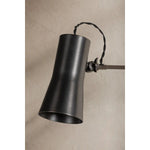 Tailored task lighting, this portable, functional swing arm sconce is also thoughtfully designed and beautiful. The sleek arm features a wooden handle on one end and an adjustable metal shade in Patina Brass or Bronze on the other. The twisted black cord detailing at the shade and backplate give Novel a nostalgic feel. Amethyst Home provides interior design, new home construction design consulting, vintage area rugs, and lighting in the Nashville metro area.