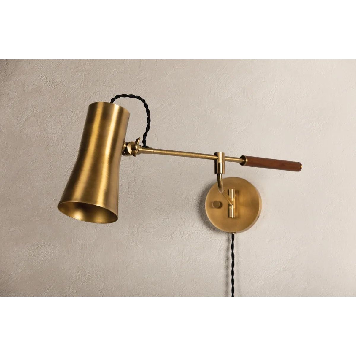 Tailored task lighting, this portable, functional swing arm sconce is also thoughtfully designed and beautiful. The sleek arm features a wooden handle on one end and an adjustable metal shade in Patina Brass or Bronze on the other. The twisted black cord detailing at the shade and backplate give Novel a nostalgic feel. Amethyst Home provides interior design, new home construction design consulting, vintage area rugs, and lighting in the Washington metro area.