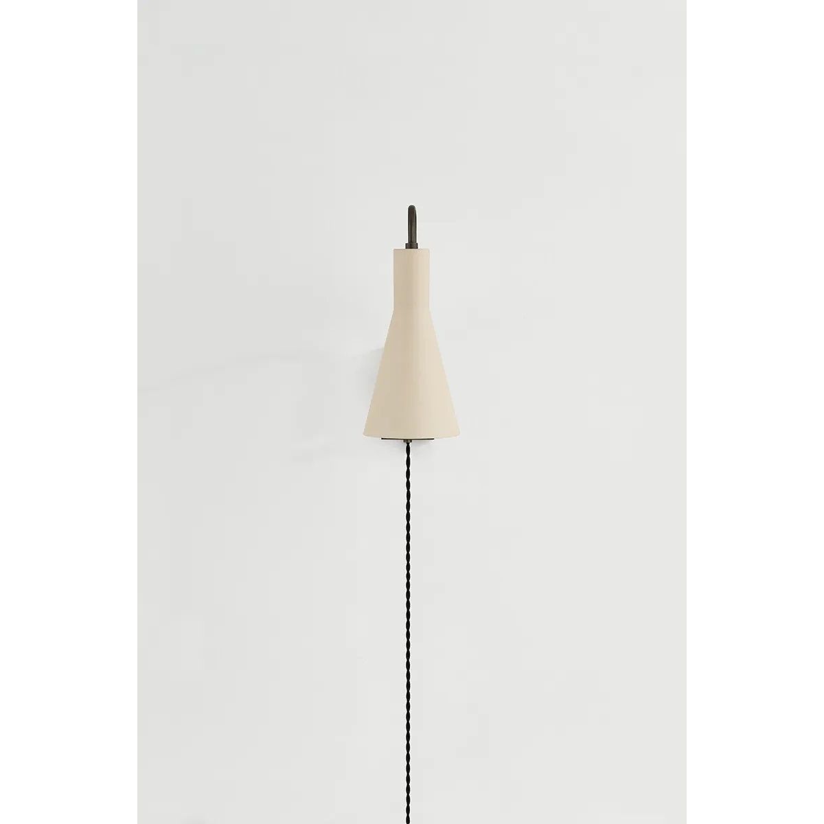 The Yvette plug-in sconce uses a modern lens to reimagine vintage design motifs. The geometry of the metalwork has been simplified to basic lines and curves, with the arc-shaped piece above the shade serving as a handle for adjustments. Finished in creamy Soft Bisque, this design-forward sconce adds plenty of directional light to a desk or bedside. Amethyst Home provides interior design, new home construction design consulting, vintage area rugs, and lighting in the Salt Lake City metro area.