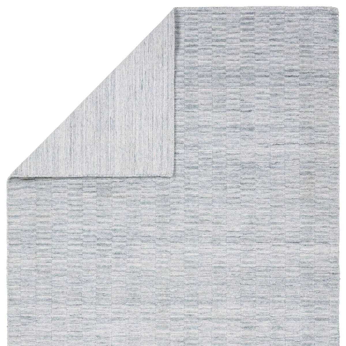 Made from 100% PET the indoor/ outdoor handwoven Roan Aaren is perfect for performance needs.  This pseudo-solid blue rug bodes a light checkered appearance with a neutral backdrop.ROA0 Amethyst Home provides interior design, new home construction design consulting, vintage area rugs, and lighting in the Boston metro area.