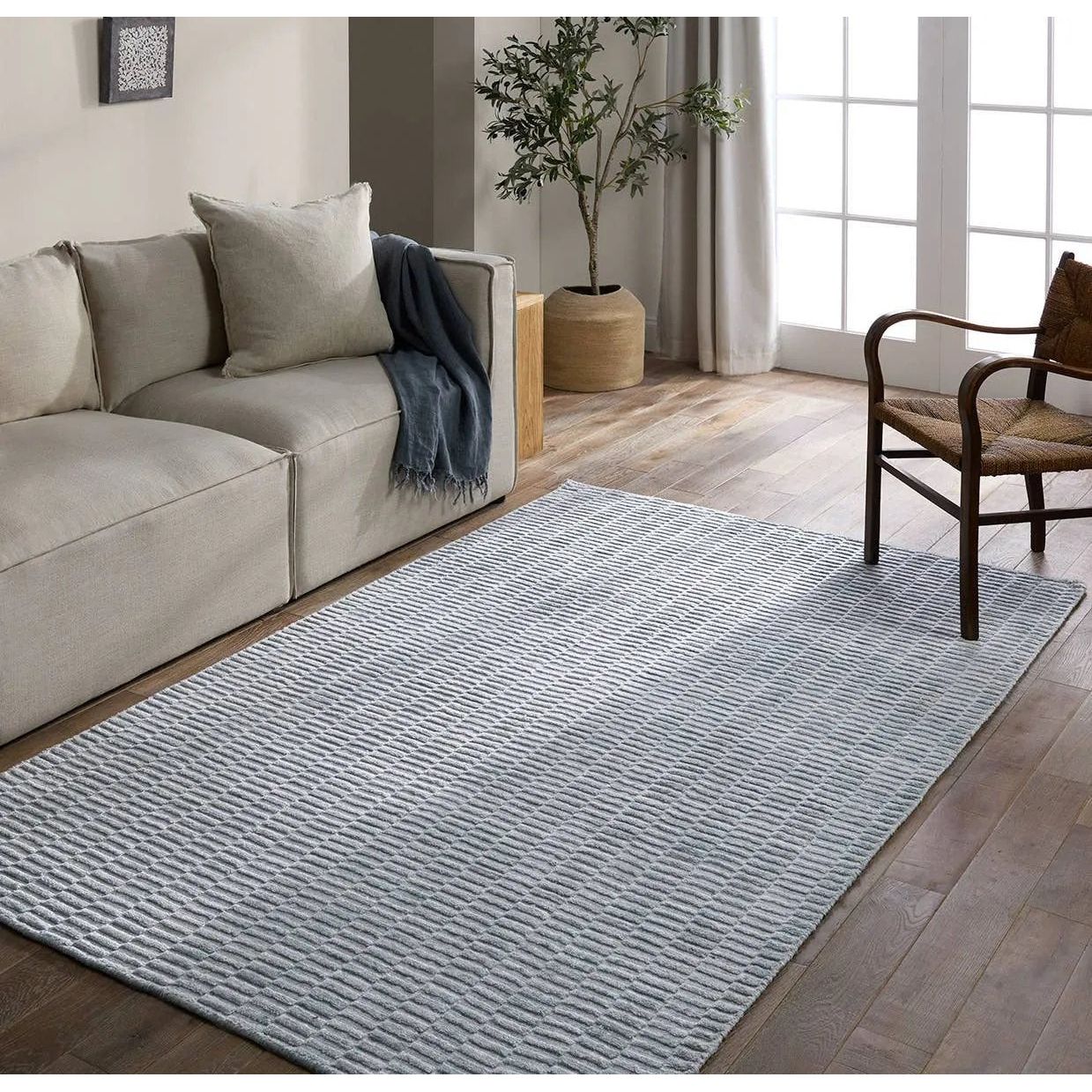 Made from 100% PET the indoor/ outdoor handwoven Roan Aaren is perfect for performance needs.  This pseudo-solid blue rug bodes a light checkered appearance with a neutral backdrop.ROA0 Amethyst Home provides interior design, new home construction design consulting, vintage area rugs, and lighting in the Salt Lake City metro area.