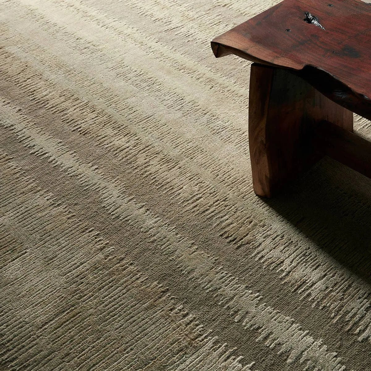 A contemporary interplay of cream and green comes to life in a striking abstract linear design. Crafted from a luxurious blend of viscose and silk, the Jovian design’s luminous sheen accentuates the depth and movement of its pattern. This handknotted piece exudes sophistication and exceptional craftsmanship, making it a stunning foundation.HIB0 Amethyst Home provides interior design, new home construction design consulting, vintage area rugs, and lighting in the Alpharetta metro area.