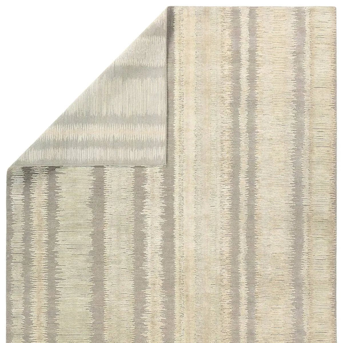 A contemporary interplay of cream and green comes to life in a striking abstract linear design. Crafted from a luxurious blend of viscose and silk, the Jovian design’s luminous sheen accentuates the depth and movement of its pattern. This handknotted piece exudes sophistication and exceptional craftsmanship, making it a stunning foundation.HIB0 Amethyst Home provides interior design, new home construction design consulting, vintage area rugs, and lighting in the Omaha metro area.