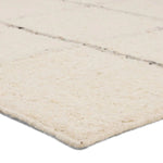 Featuring Leona Coart Rug by Jaipur Living at Amethyst Home. With its lofty, handmade loops, the Coart rug is an inviting, textural essential. Crafted of 100% undyed wool, its natural, relaxed, persona is met with a crisp, contemporary grid pattern.  An outstanding union of artistry and contemporary style, its physical approachability, monochromatic palette, a. Amethyst Home provides interior design, new home construction design consulting, vintage area rugs, and lighting in the Austin metro area.