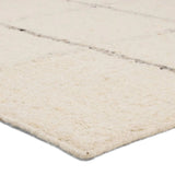 Featuring Leona Coart Rug by Jaipur Living at Amethyst Home. With its lofty, handmade loops, the Coart rug is an inviting, textural essential. Crafted of 100% undyed wool, its natural, relaxed, persona is met with a crisp, contemporary grid pattern.  An outstanding union of artistry and contemporary style, its physical approachability, monochromatic palette, a. Amethyst Home provides interior design, new home construction design consulting, vintage area rugs, and lighting in the Austin metro area.