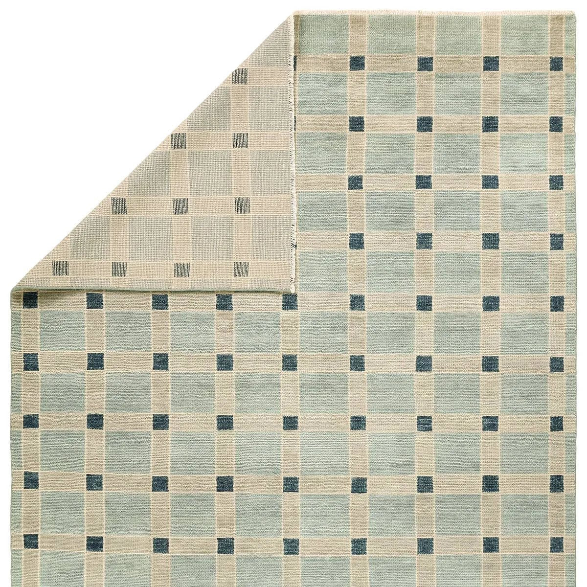 The Quinlan design reinvents timeless geometric patterns, fusing classic charm with a modern edge. Soft beige tones, punctuated by a blue accent, elevate any mid-century modern space. Handcrafted from naturally stain-resistant wool, this rug handles medium-traffic areas, kids, and pets with ease. Amethyst Home provides interior design, new home construction design consulting, vintage area rugs, and lighting in the Seattle metro area.