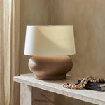 Featuring Kragen Dark Sand Porcelain Ceramic Table Lamp by Four Hands at Amethyst Home. A wide table lamp of sand-finished ceramic pairs with an ivory shade of flax and linen.Overall Dimensions: 18.00"w x 18.00"d x 23.00"hWeight : 18.76 lbsMaterials : Ceramic, 65% Polyester, 35% Flax/Linen. Amethyst Home provides interior design, new construction, custom furniture, and area rugs in the Seattle metro area