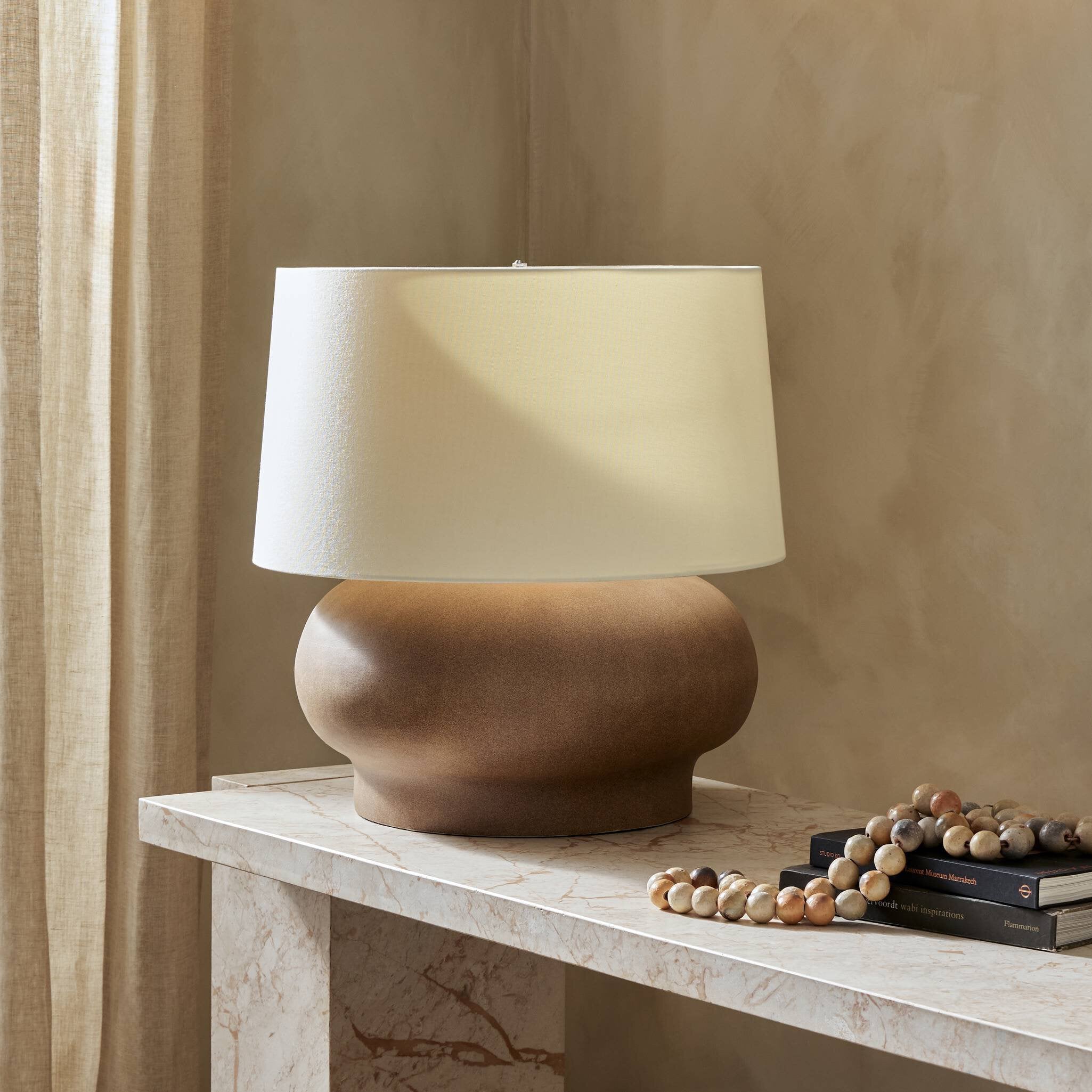 Featuring Kragen Dark Sand Porcelain Ceramic Table Lamp by Four Hands at Amethyst Home. A wide table lamp of sand-finished ceramic pairs with an ivory shade of flax and linen.Overall Dimensions: 18.00"w x 18.00"d x 23.00"hWeight : 18.76 lbsMaterials : Ceramic, 65% Polyester, 35% Flax/Linen. Amethyst Home provides interior design, new construction, custom furniture, and area rugs in the Seattle metro area