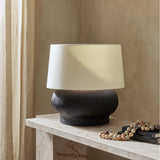 Featuring Kragen Textured Matte Black Porcelain Ceramic Table Lamp by Four Hands at Amethyst Home. A wide, textured table lamp of black-finished ceramic pairs with an ivory shade of flax and linen.Overall Dimensions: 18.00"w x 18.00"d x 23.00"hWeight : 19.27 lbsMaterials : Ceramic, 65% Polyester, 35% Flax/Linen. Amethyst Home provides interior design, new construction, custom furniture, and area rugs in the Park City metro area
