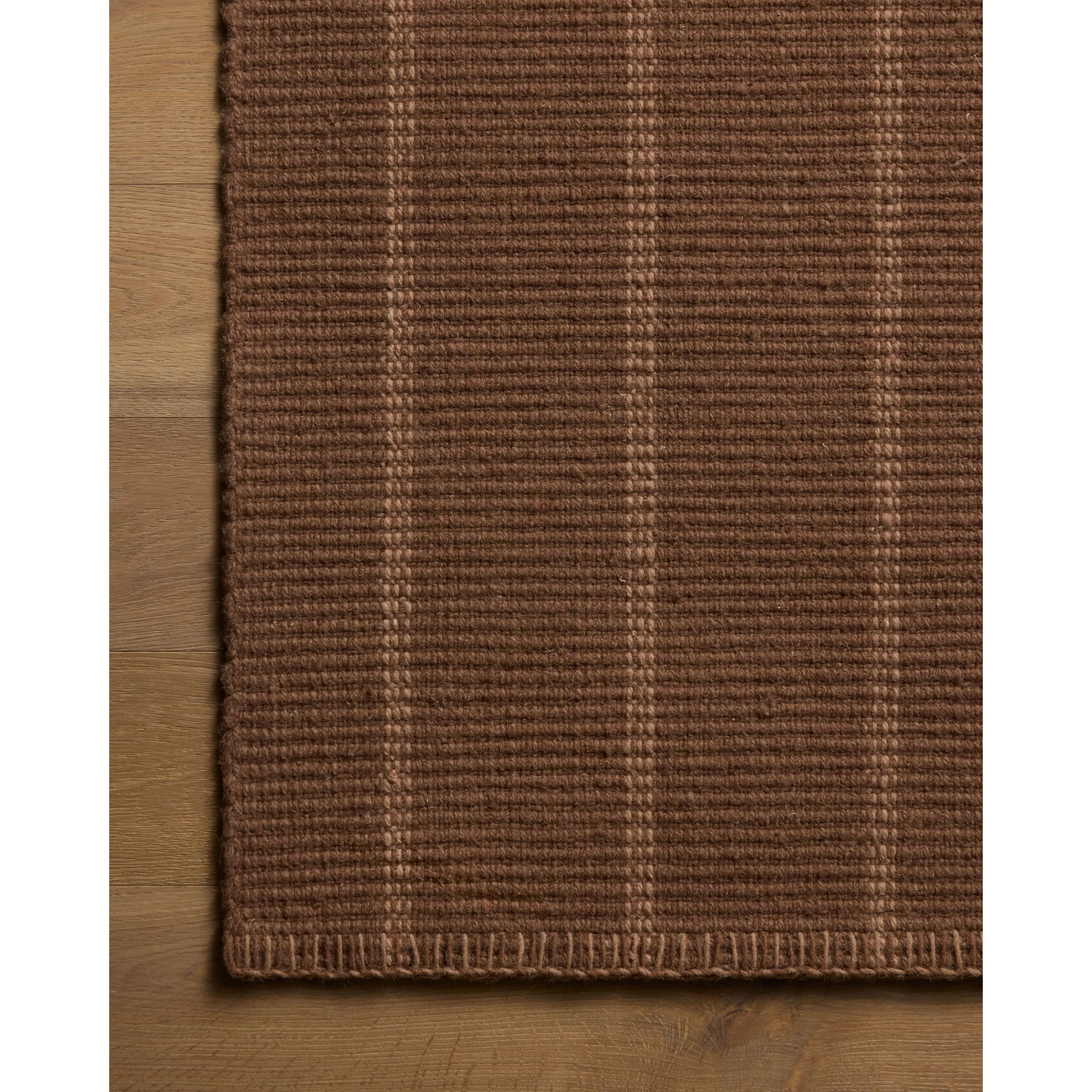 The Harlan Collection by Amber Lewis x Loloi is a classic striped flatweave area rug in the interior designer’s signature warm, earthy tones. The rug has a chunky wool pile with whipstitch borders that add character and natural texture to living rooms, bedrooms, and other well-loved areas of the home. Amethyst Home provides interior design, new home construction design consulting, vintage area rugs, and lighting in the Tampa metro area.