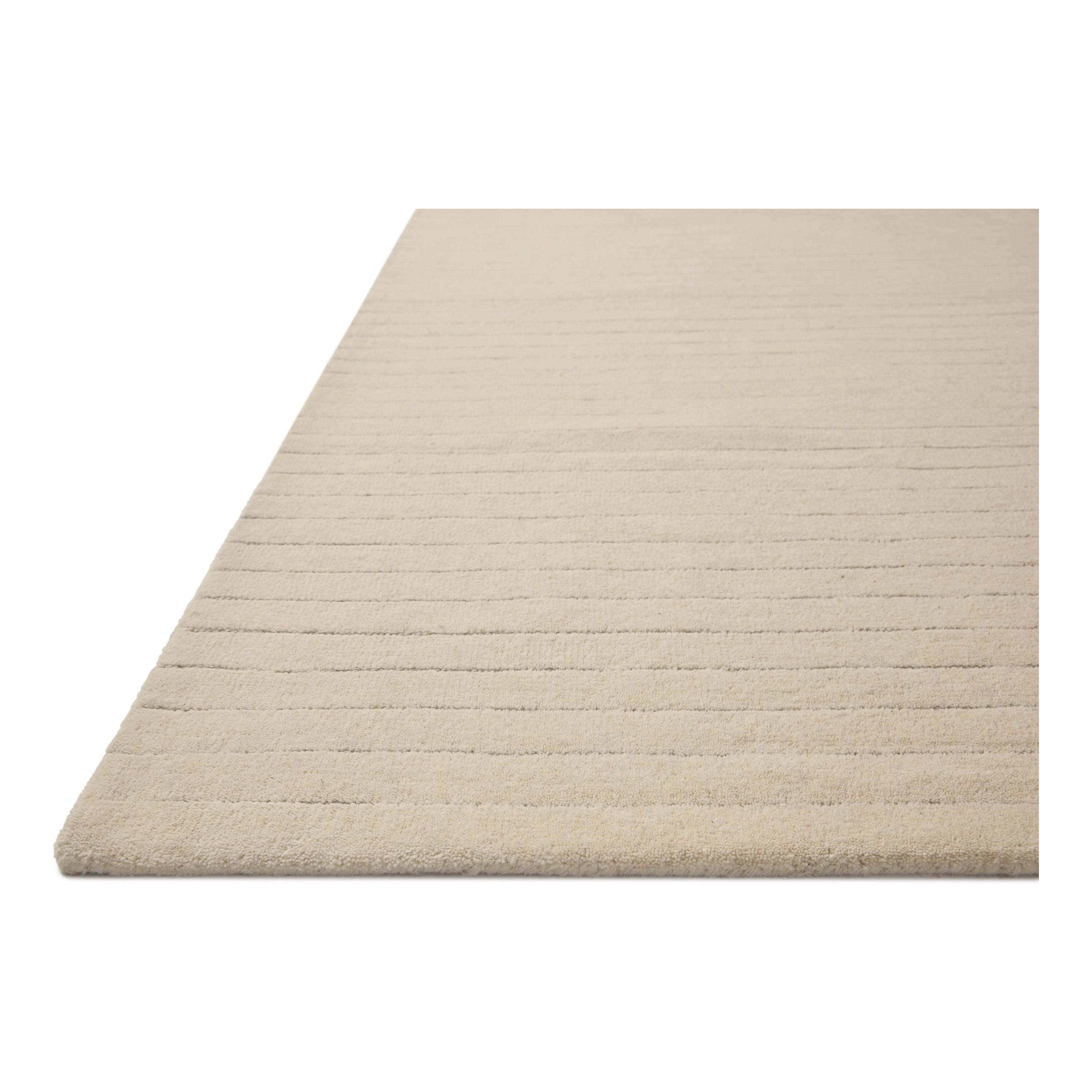 The Henry Collection from Chris Loves Julia x Loloi is a hand-tufted area rug that adds a touch of personality to a solid-colored design that can easily pair with other patterns in the room. These designs feature tufted stripes for subtle contrast and depth. The rugs wool pile is thick and satisfying to walk on, with gently nuanced color variation. Amethyst Home provides interior design, new home construction design consulting, vintage area rugs, and lighting in the Kansas City metro area.