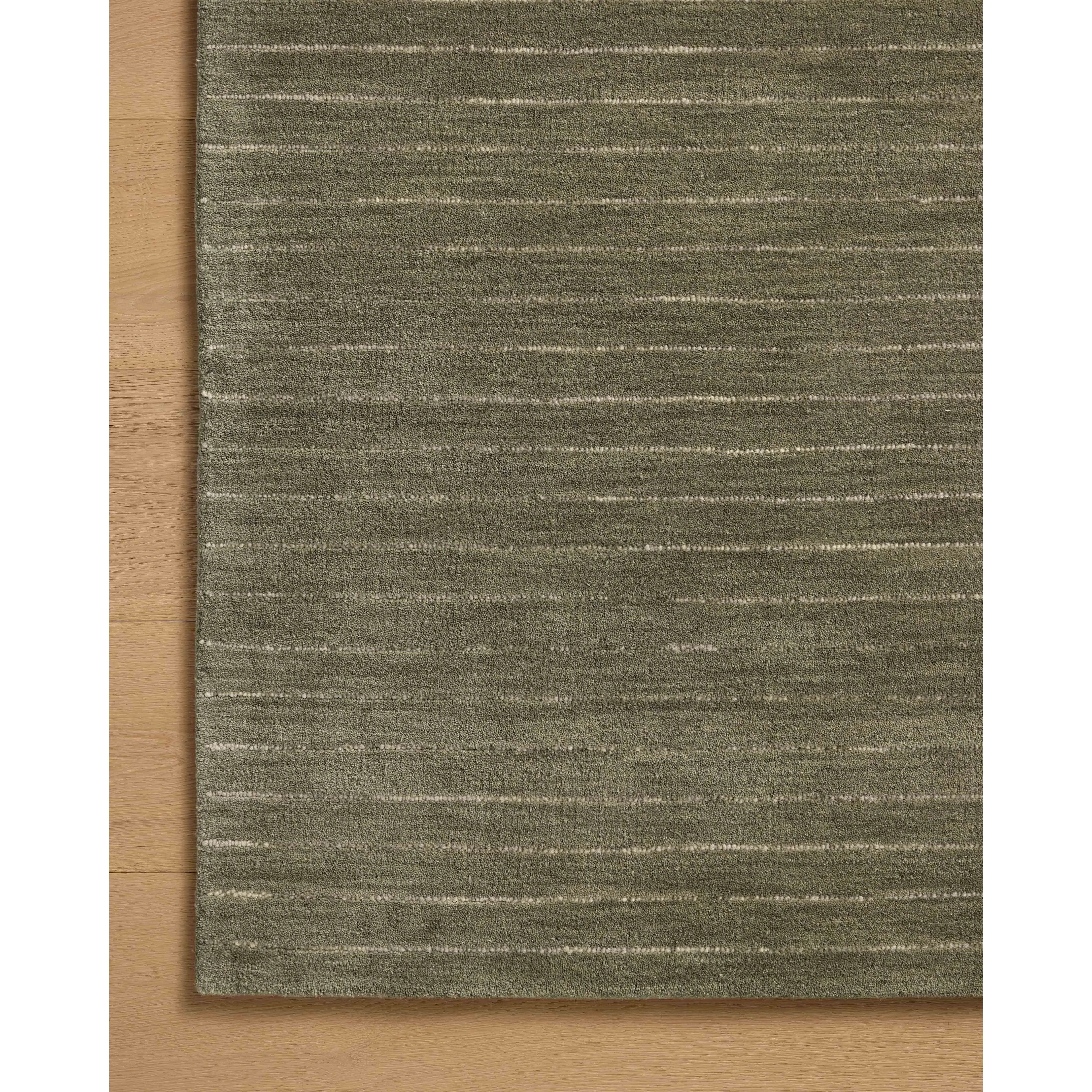 The Henry Collection from Chris Loves Julia x Loloi is a hand-tufted area rug that adds a touch of personality to a solid-colored design that can easily pair with other patterns in the room. These designs feature tufted stripes for subtle contrast and depth. The rugs wool pile is thick and satisfying to walk on, with gently nuanced color variation. Amethyst Home provides interior design, new home construction design consulting, vintage area rugs, and lighting in the Charlotte metro area.