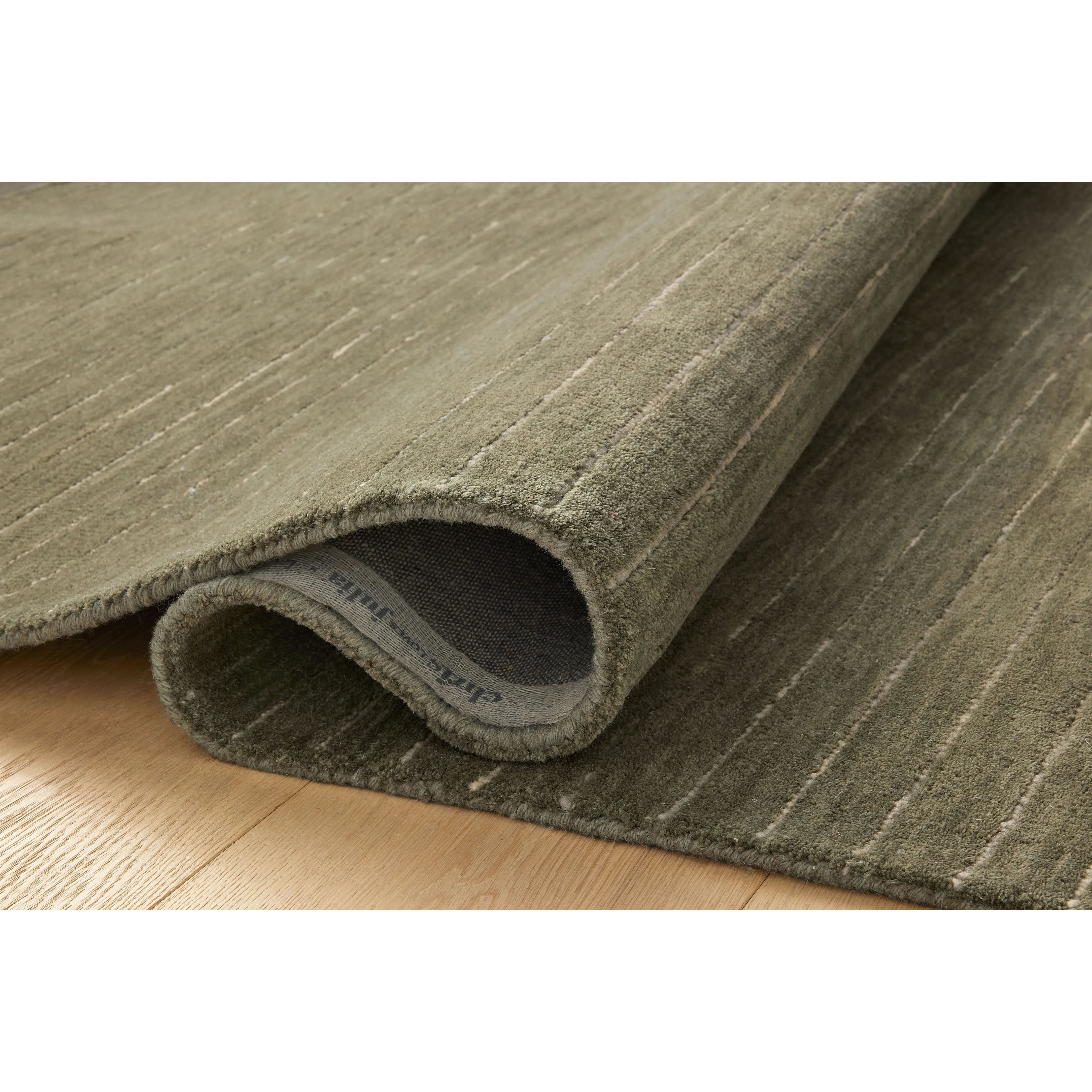 The Henry Collection from Chris Loves Julia x Loloi is a hand-tufted area rug that adds a touch of personality to a solid-colored design that can easily pair with other patterns in the room. These designs feature tufted stripes for subtle contrast and depth. The rugs wool pile is thick and satisfying to walk on, with gently nuanced color variation. Amethyst Home provides interior design, new home construction design consulting, vintage area rugs, and lighting in the Nashville metro area.