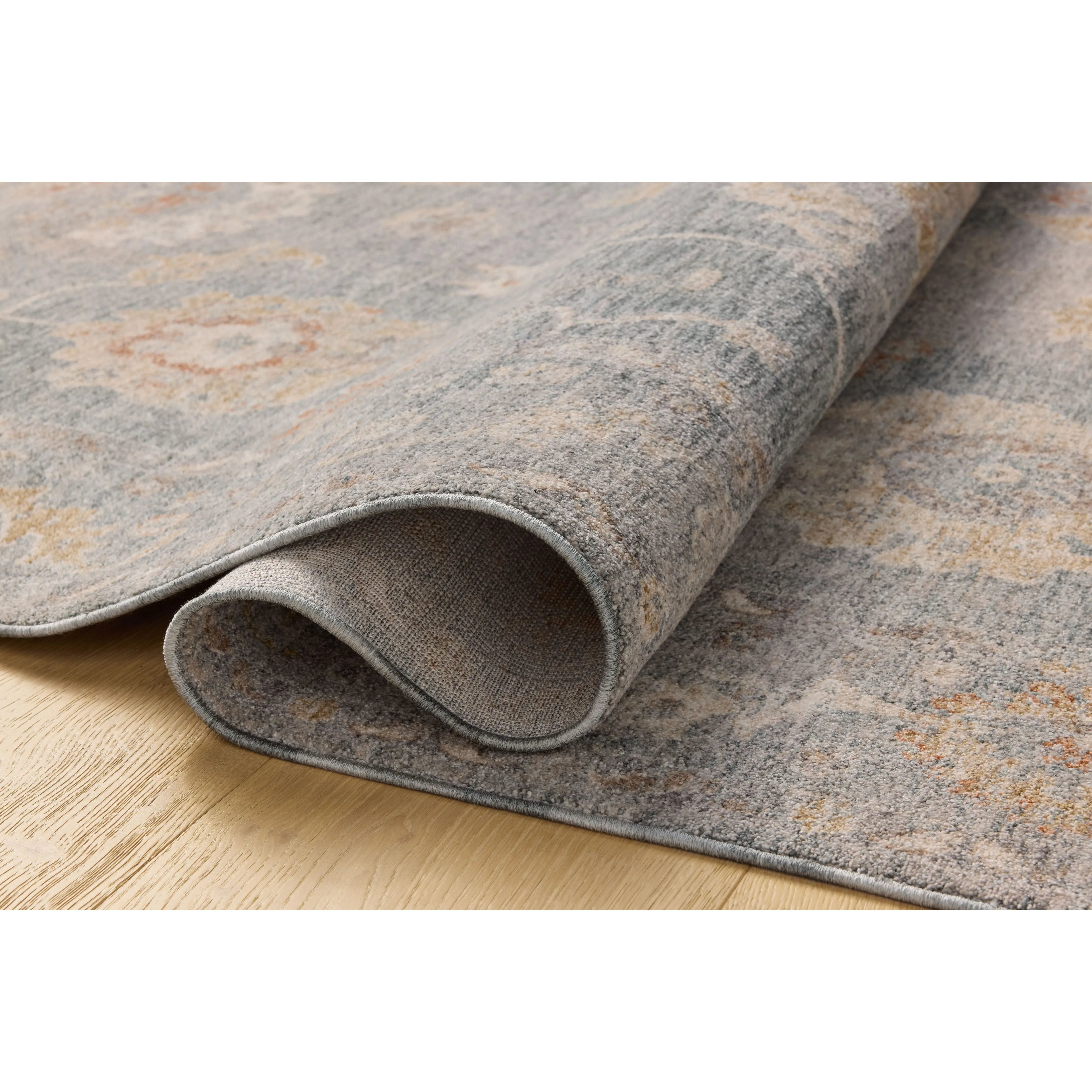 The Louisa Collection is a serene area rug based on beautiful, traditional Turkish designs updated in calm colorways by Chris Loves Julia in collaboration with Loloi. Pale blues, creams, and browns create a sense of softness, but so does the rugs pile, which is made of easy-to-clean, velvety polyester. Amethyst Home provides interior design, new home construction design consulting, vintage area rugs, and lighting in the Park City metro area.