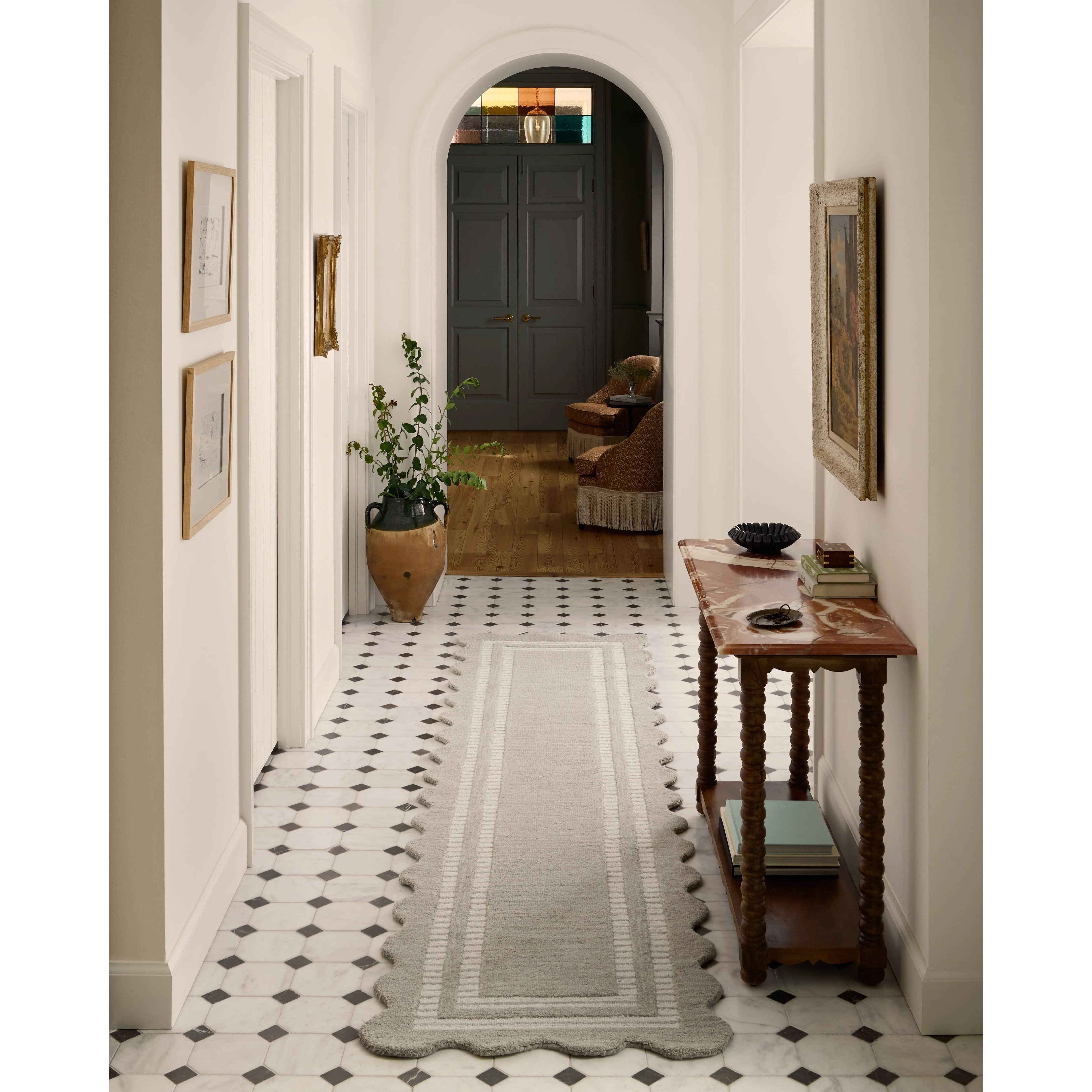 Featuring Chris Loves Julia × Loloi Scottie Fog / Ivory Rug by Loloi at Amethyst Home. The Scottie Collection from Chris Loves Julia x Loloi is a hand-tufted wool area rug with a playful scalloped edge and lower-pile, striped border for a touch of structure. The rugs overall pile is thick and plush, available in easygoing earth tones and neutral colorways. . Amethyst Home provides interior design, new home construction design consulting, vintage area rugs, and lighting in the Charlotte metro area.