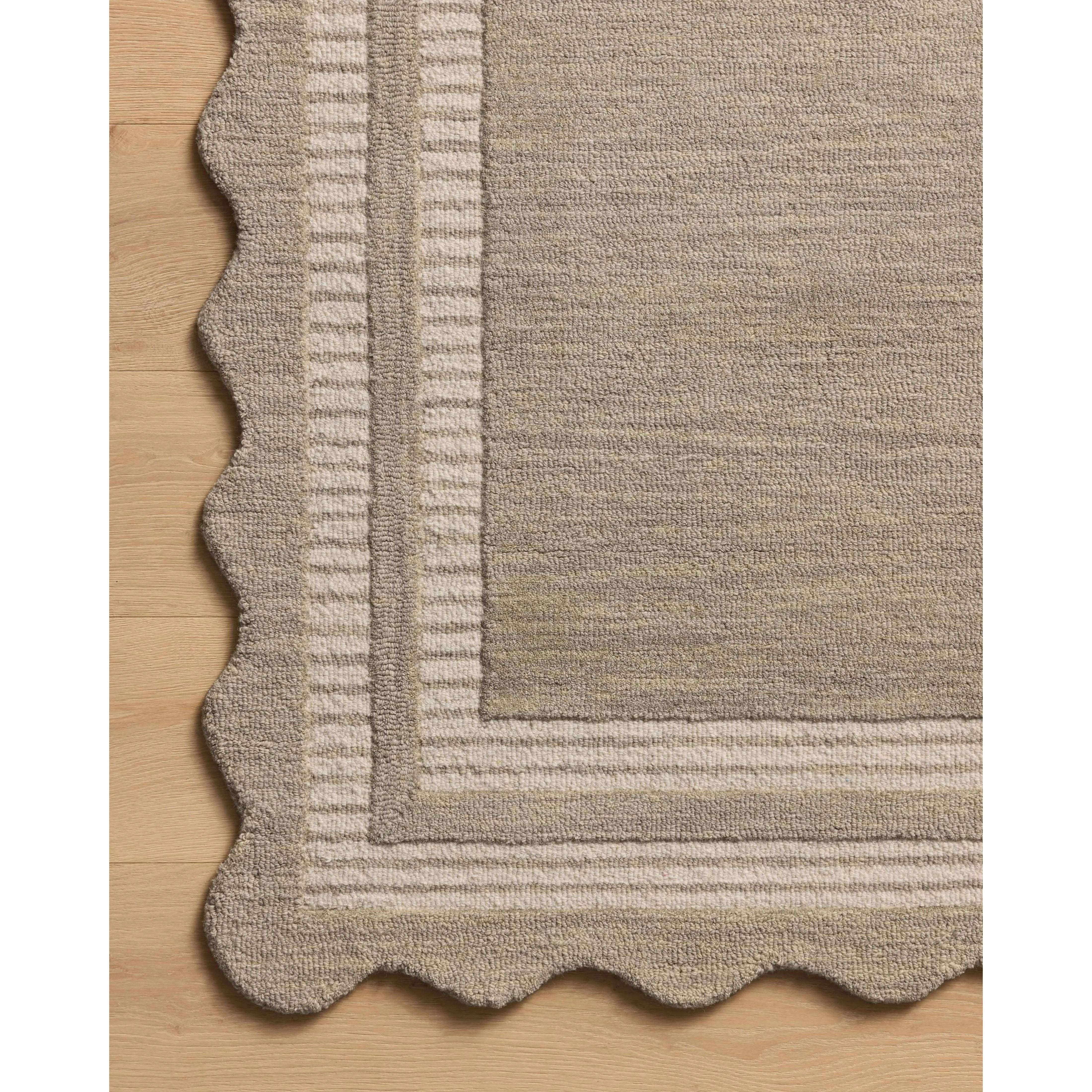 Featuring Chris Loves Julia × Loloi Scottie Fog / Ivory Rug by Loloi at Amethyst Home. The Scottie Collection from Chris Loves Julia x Loloi is a hand-tufted wool area rug with a playful scalloped edge and lower-pile, striped border for a touch of structure. The rugs overall pile is thick and plush, available in easygoing earth tones and neutral colorways. . Amethyst Home provides interior design, new home construction design consulting, vintage area rugs, and lighting in the Park City metro area.
