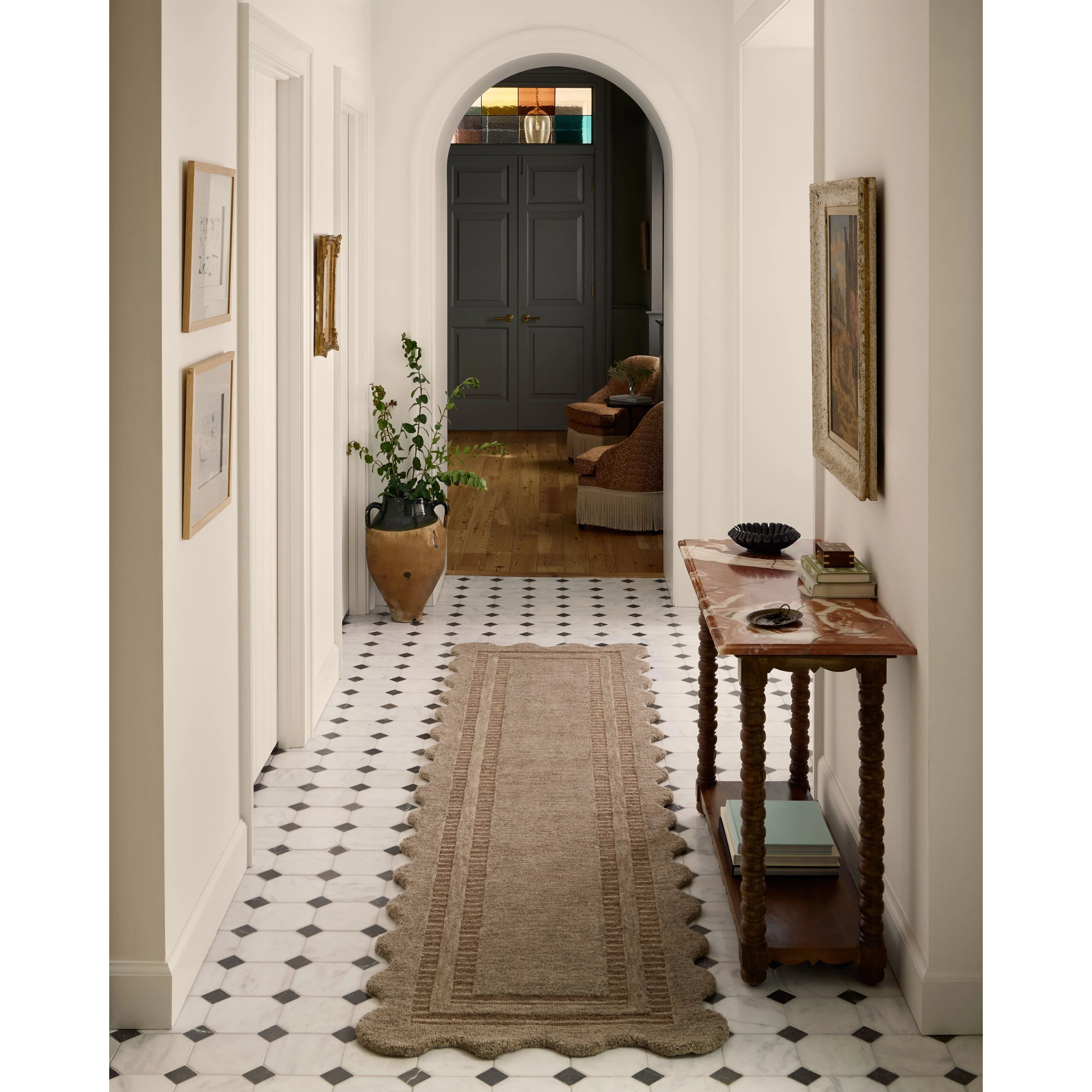 Featuring Chris Loves Julia × Loloi Scottie Mocha / Clay Rug by Loloi at Amethyst Home. The Scottie Collection from Chris Loves Julia x Loloi is a hand-tufted wool area rug with a playful scalloped edge and lower-pile, striped border for a touch of structure. The rugs overall pile is thick and plush, available in easygoing earth tones and neutral colorways. Thi. Amethyst Home provides interior design, new home construction design consulting, vintage area rugs, and lighting in the Miami metro area.