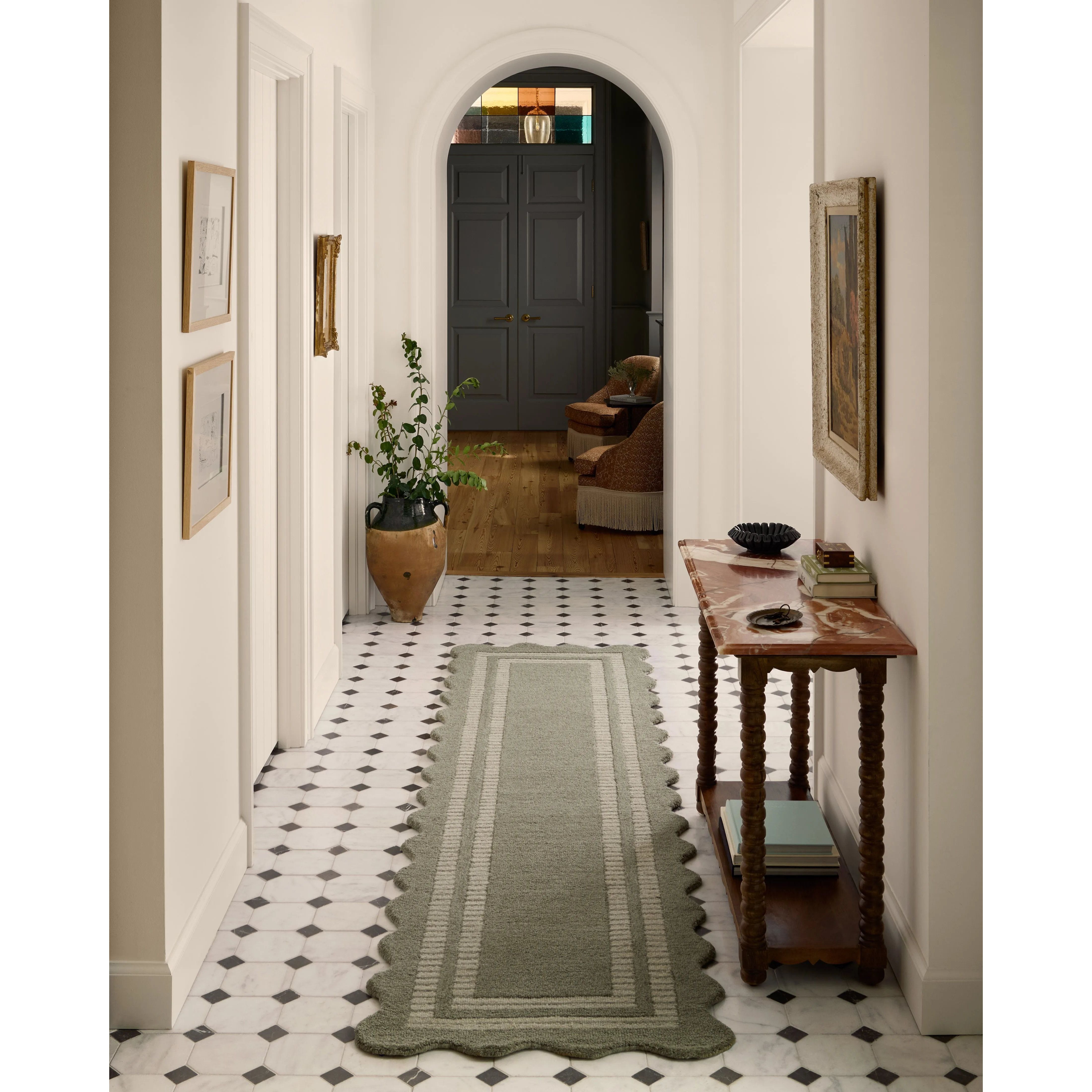 Featuring Chris Loves Julia × Loloi Scottie Olive / Pebble Rug by Loloi at Amethyst Home. The Scottie Collection from Chris Loves Julia x Loloi is a hand-tufted wool area rug with a playful scalloped edge and lower-pile, striped border for a touch of structure. The rugs overall pile is thick and plush, available in easygoing earth tones and neutral colorwa. Amethyst Home provides interior design, new home construction design consulting, vintage area rugs, and lighting in the Des Moines metro area.