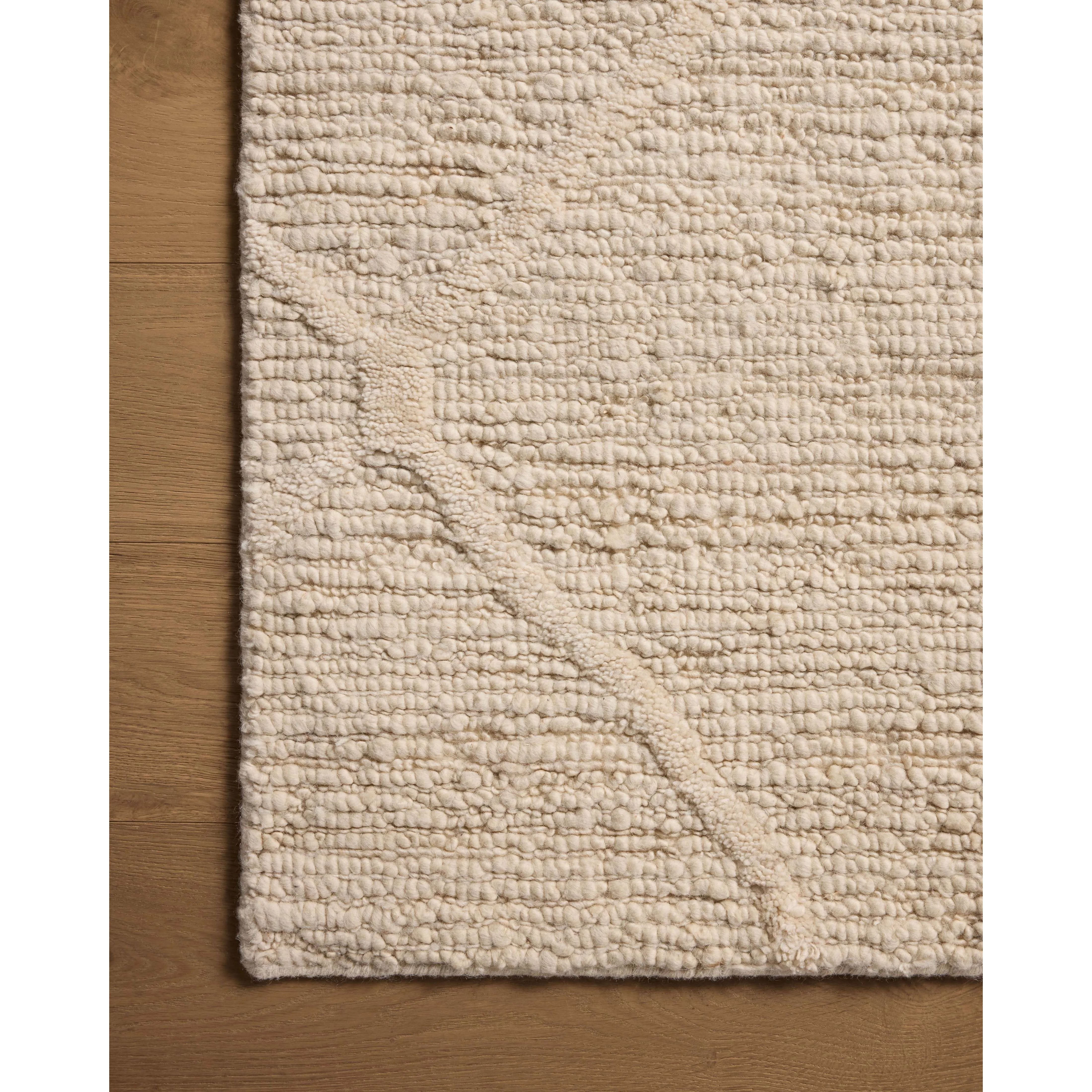 Featuring Cline Ivory Rug by Loloi at Amethyst Home. The Cline Collection is a hand-woven area rug with loose, organic raised patterns across a pleasantly chunky pile. The rug's palette is inspired by color-flecked stones, making it a dynamic neutral in living rooms, bedrooms, and more. This collection is made of 100% wool in India and GoodWeave-certified, . Amethyst Home provides interior design, new home construction design consulting, vintage area rugs, and lighting in the San Diego metro area.