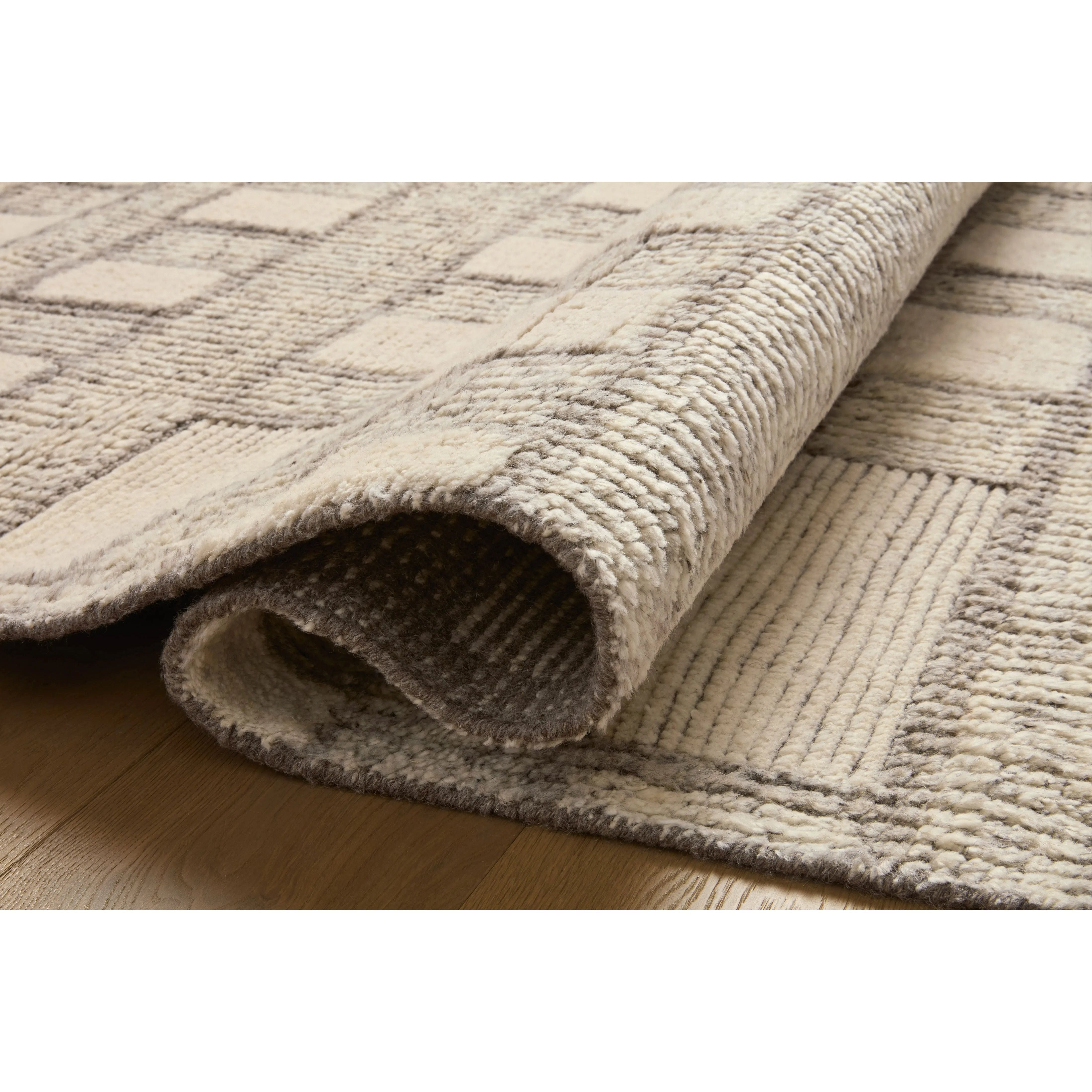 Featuring David Jean Stoffer x Loloi Grey Hand-Knotted Rug by Loloi at Amethyst Home. Unexpected stripes trace along the David Collection, a hand-knotted area rug with a plush, luxurious presence. Abstract patterns are carved into the design for a richly textured pile that's satisfying to sink into. This collection is made of 100% wool in India and GoodWeav. Amethyst Home provides interior design, new home construction design consulting, vintage area rugs, and lighting in the Charlotte metro area.