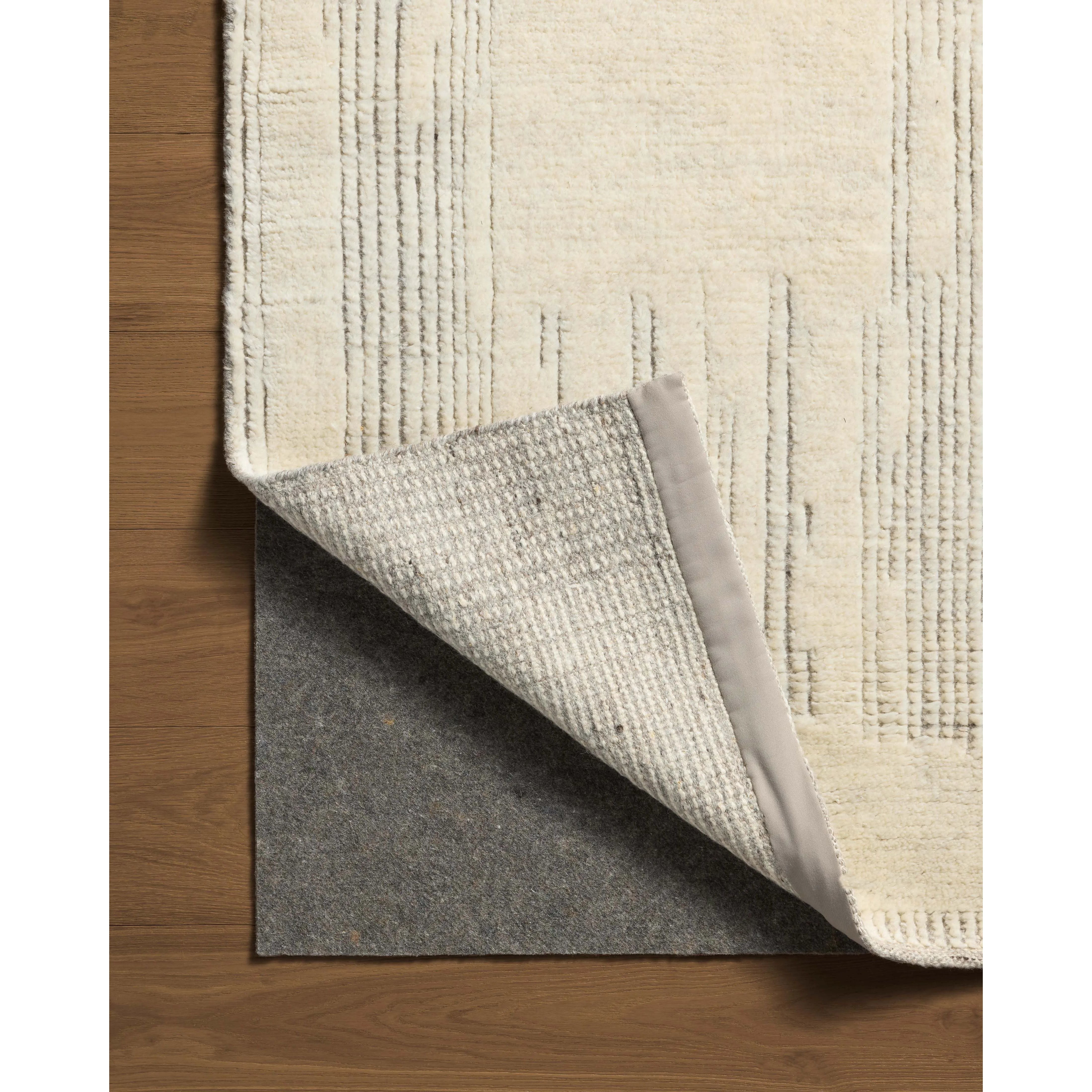 Featuring David Jean Stoffer x Loloi Ivory Hand-Knotted Rug by Loloi at Amethyst Home. Unexpected stripes trace along the David Collection, a hand-knotted area rug with a plush, luxurious presence. Abstract patterns are carved into the design for a richly textured pile that's satisfying to sink into. This collection is made of 100% wool in India and Goo. Amethyst Home provides interior design, new home construction design consulting, vintage area rugs, and lighting in the Newport Beach metro area.