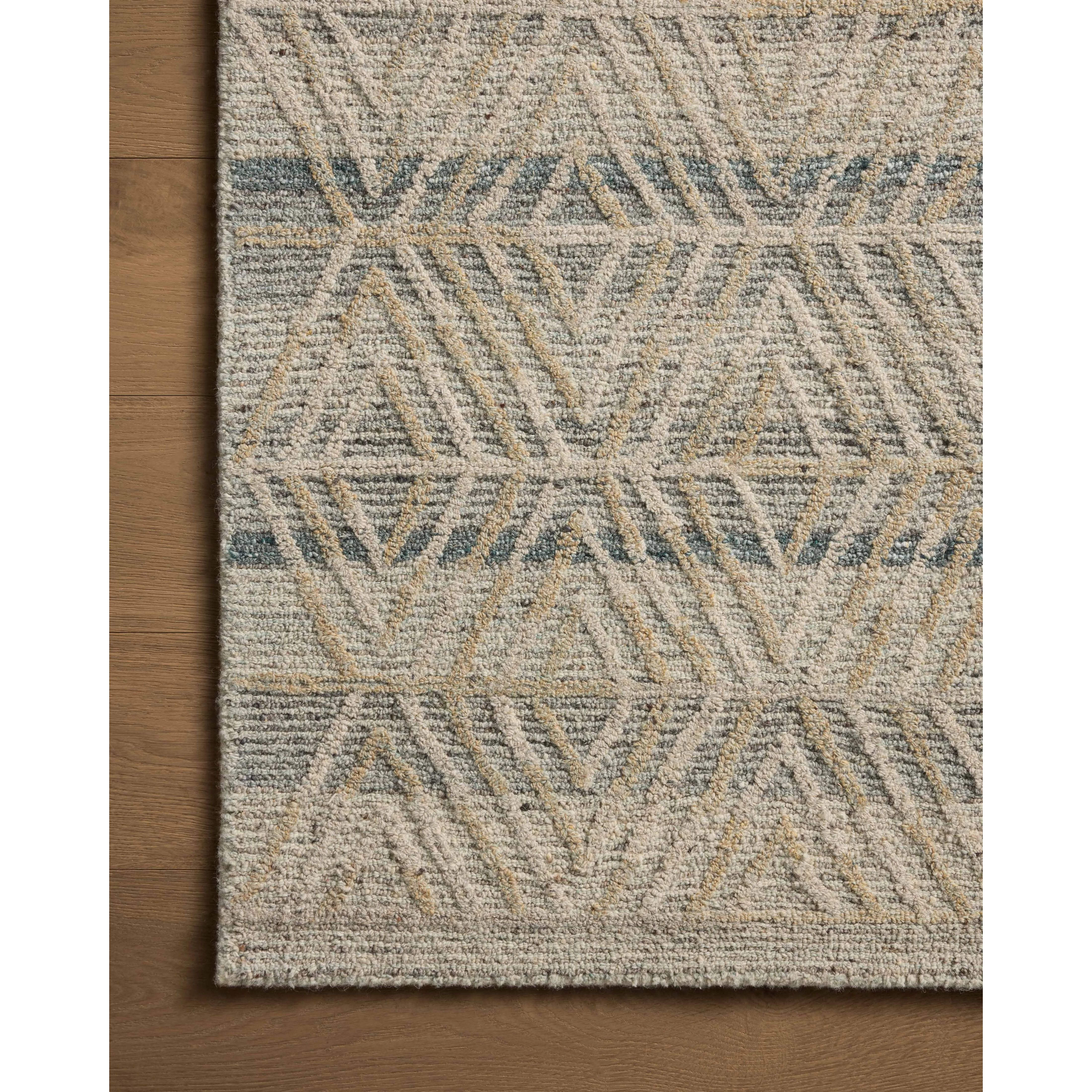 The Elias Fog / Natural Rug is a hand-tufted wool area rug with lively graphic patterns in earth and stone tones. There’s a unique texture to the rug made by over-tufting, in which a design is hand-tufted over a tufted base, creating a subtle high-low pile. Amethyst Home provides interior design, new home construction design consulting, vintage area rugs, and lighting in the Charlotte metro area.