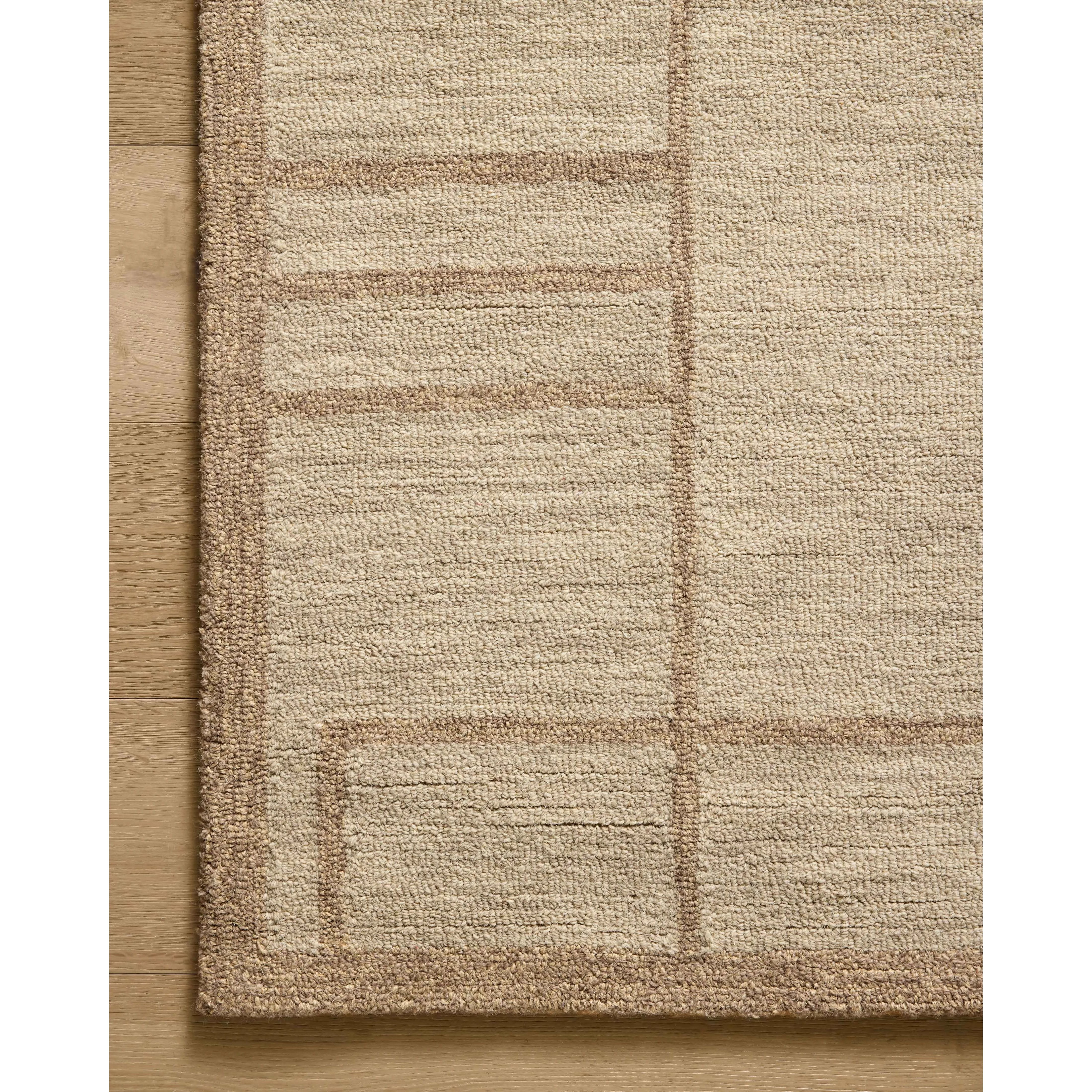 The Barrow Collection by Jeremiah Brent x Loloi is a hand-tufted area rug with a bold linear design inspired by modern art and classical architecture. The rugs pile is a blend of wool and jute for a stable, substantial feel that can ground living rooms, dining rooms, bedrooms, and more. Amethyst Home provides interior design, new home construction design consulting, vintage area rugs, and lighting in the Austin metro area.