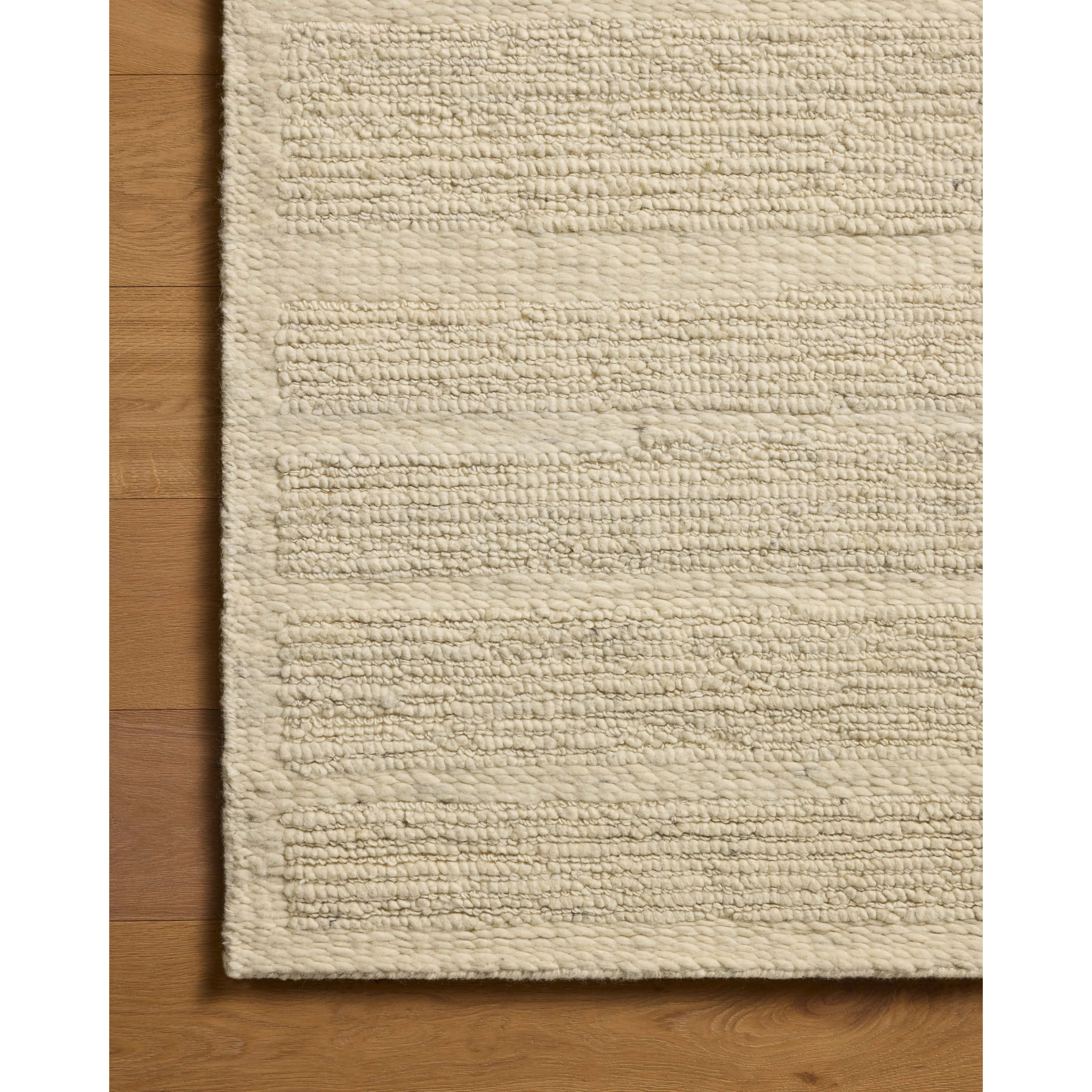 The Lennox Collection by Leanne Ford x Loloi is a statement area rug made with natural undyed wool that reveals subtle color differentiation in creamy neutral tones. The rug is hand-woven with a labor-intensive soumak weave, alternating rows of thick and thin looped yarns for an organic, inviting texture. Amethyst Home provides interior design, new home construction design consulting, vintage area rugs, and lighting in the Calabasas metro area.