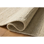 The Lennox Collection by Leanne Ford x Loloi is a statement area rug made with natural undyed wool that reveals subtle color differentiation in creamy neutral tones. The rug is hand-woven with a labor-intensive soumak weave, alternating rows of thick and thin looped yarns for an organic, inviting texture. Amethyst Home provides interior design, new home construction design consulting, vintage area rugs, and lighting in the Nashville metro area.