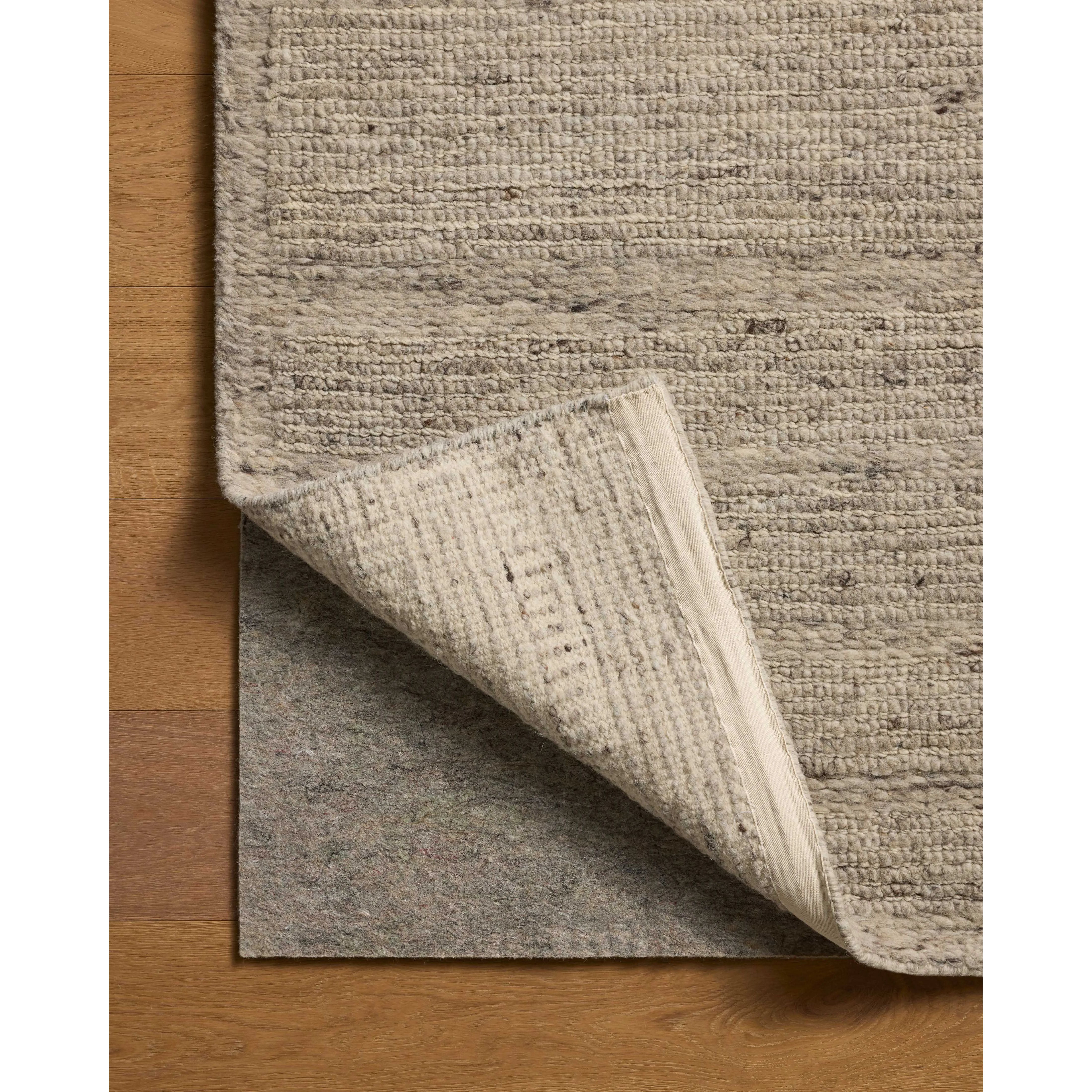 The Lennox Collection by Leanne Ford x Loloi is a statement area rug made with natural undyed wool that reveals subtle color differentiation in creamy neutral tones. The rug is hand-woven with a labor-intensive soumak weave, alternating rows of thick and thin looped yarns for an organic, inviting texture. Amethyst Home provides interior design, new home construction design consulting, vintage area rugs, and lighting in the Tampa metro area.