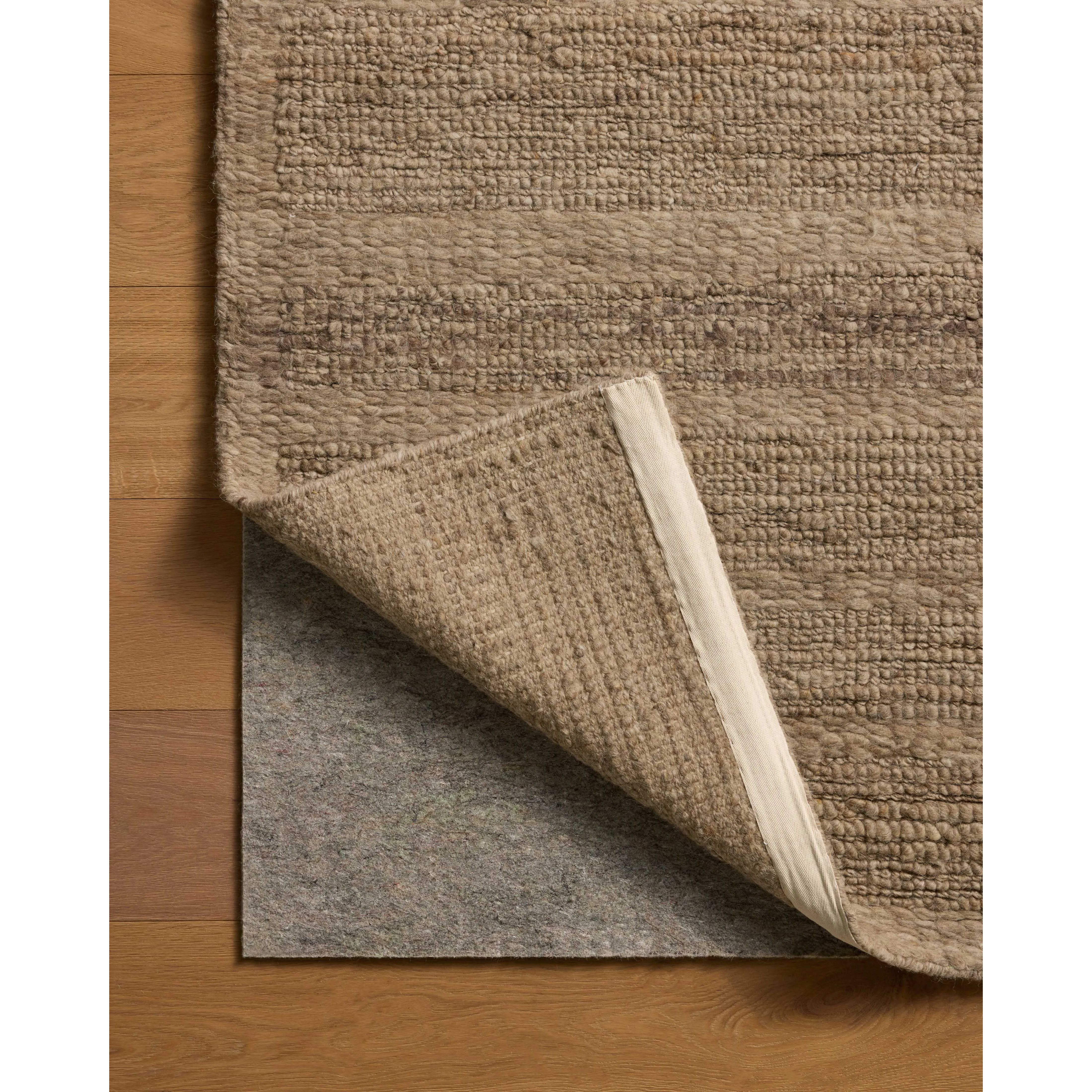 The Lennox Collection by Leanne Ford x Loloi is a statement area rug made with natural undyed wool that reveals subtle color differentiation in creamy neutral tones. The rug is hand-woven with a labor-intensive soumak weave, alternating rows of thick and thin looped yarns for an organic, inviting texture. Amethyst Home provides interior design, new home construction design consulting, vintage area rugs, and lighting in the Laguna Beach metro area.