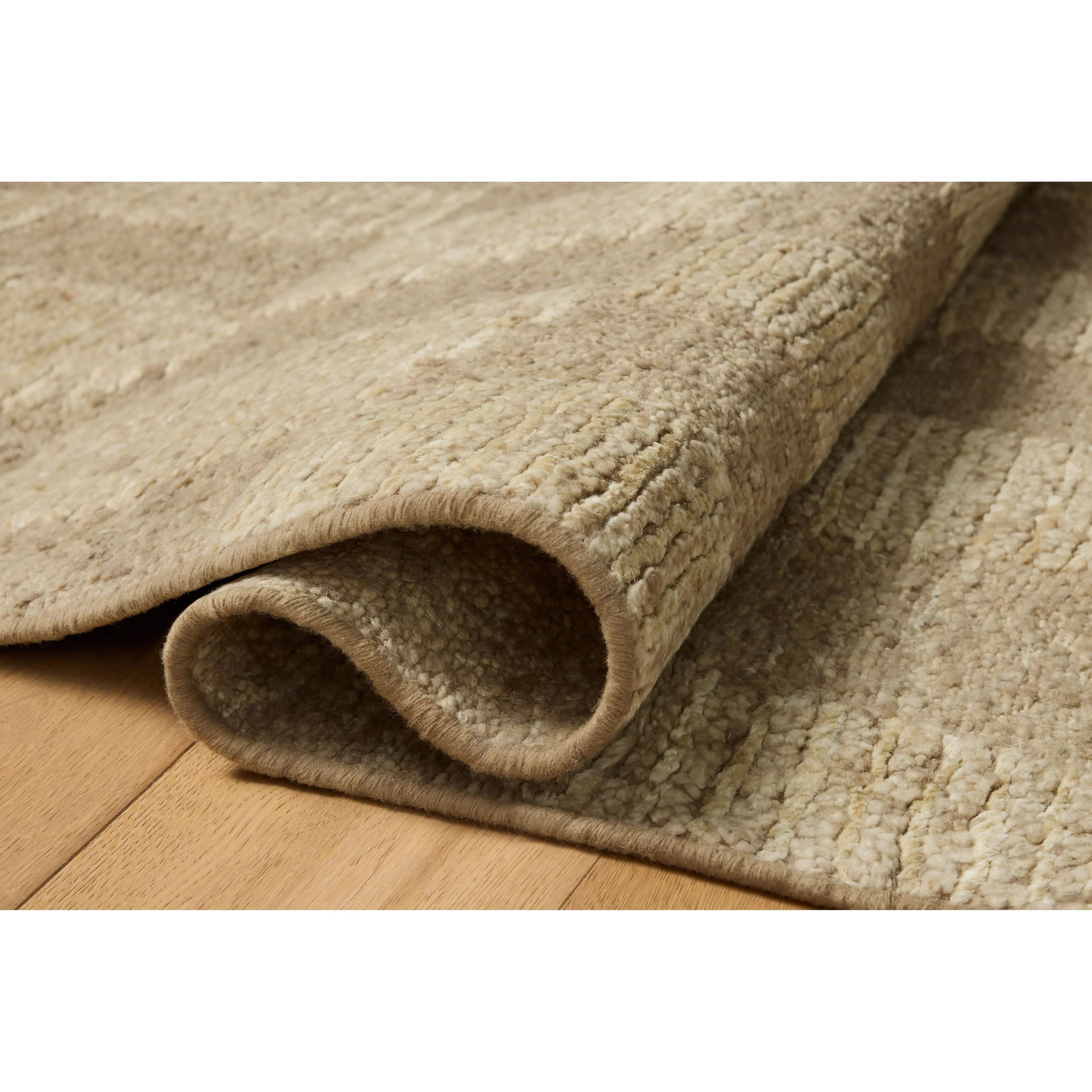 The Sowerby Collection is a wonderfully textural area rug by Leanne Ford x Loloi with a unique construction: alternating high-cut wool and jute pile on a nubby flatweave base to create an organic checkerboard pattern. Available in creamy neutrals and rich, earthy tones, Sowerby is a sophisticated neutral rug for living rooms, bedrooms, and more. Amethyst Home provides interior design, new home construction design consulting, vintage area rugs, and lighting in the Nashville metro area.