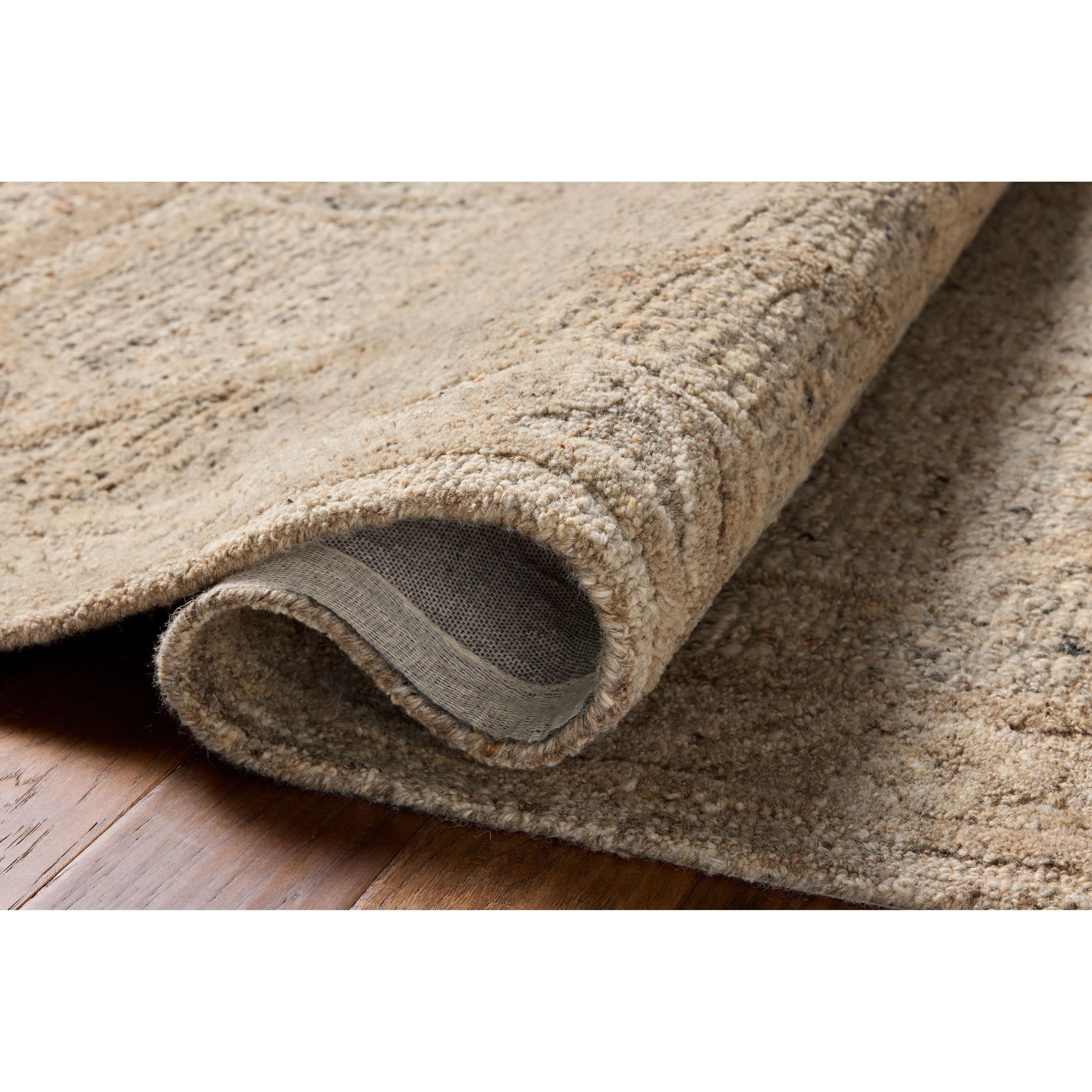 The Mabel Collection is a chunky wool area rug with a modernized take on traditional Turkish design. The rugs pattern rises with a higher pile for added dimension, while the neutral stone palette makes it easy to style in living rooms, bedrooms, and more. Amethyst Home provides interior design, new home construction design consulting, vintage area rugs, and lighting in the Dallas metro area.