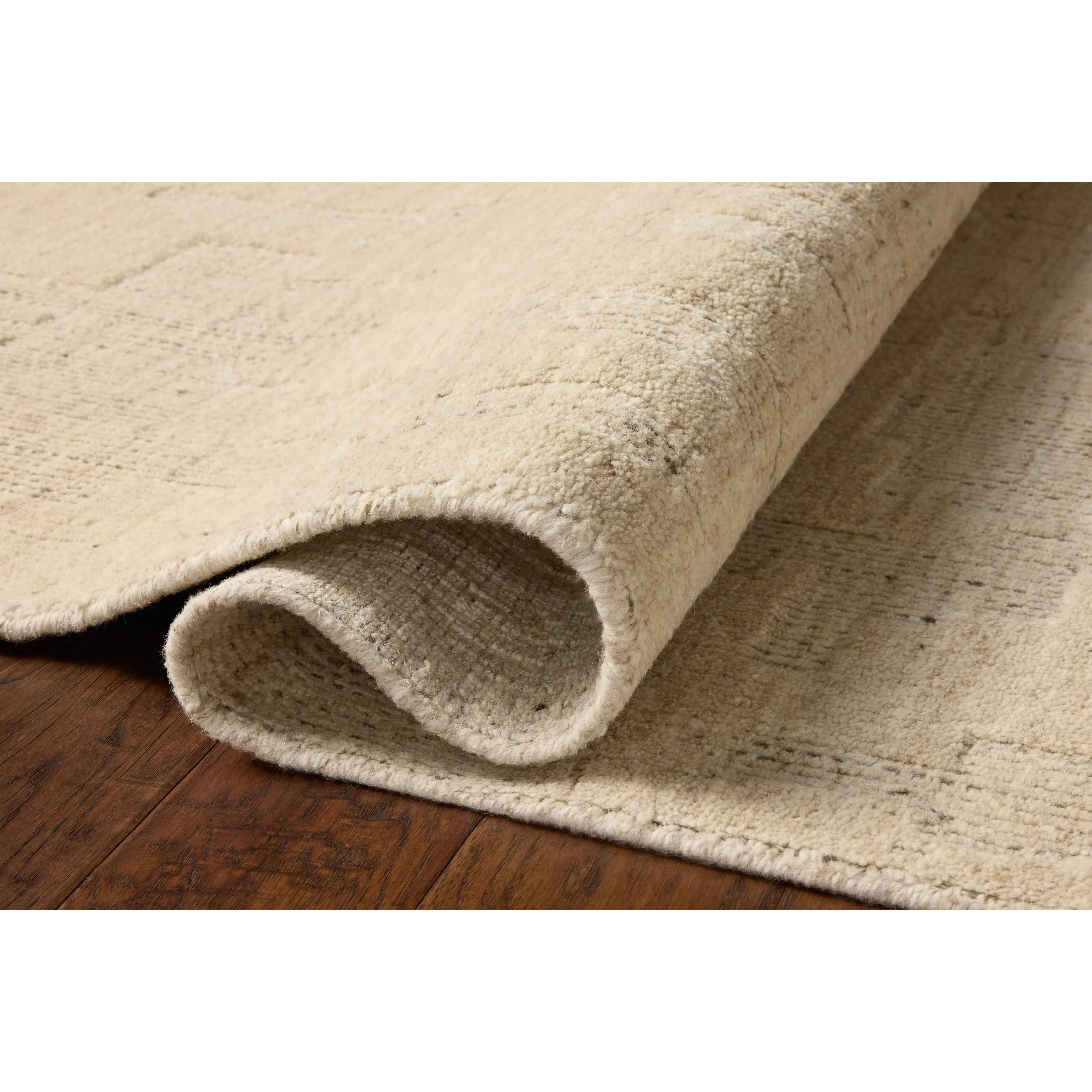 The Maren Collection is a unique handmade area rug made with a new technique that creates a dotted texture, almost like fine embroidery, but with a substantial hand-loomed feel. The pile reveals modern geometric patterns with organic shapes and natural softness, available in light, easygoing neutrals. Amethyst Home provides interior design, new home construction design consulting, vintage area rugs, and lighting in the Monterey metro area.