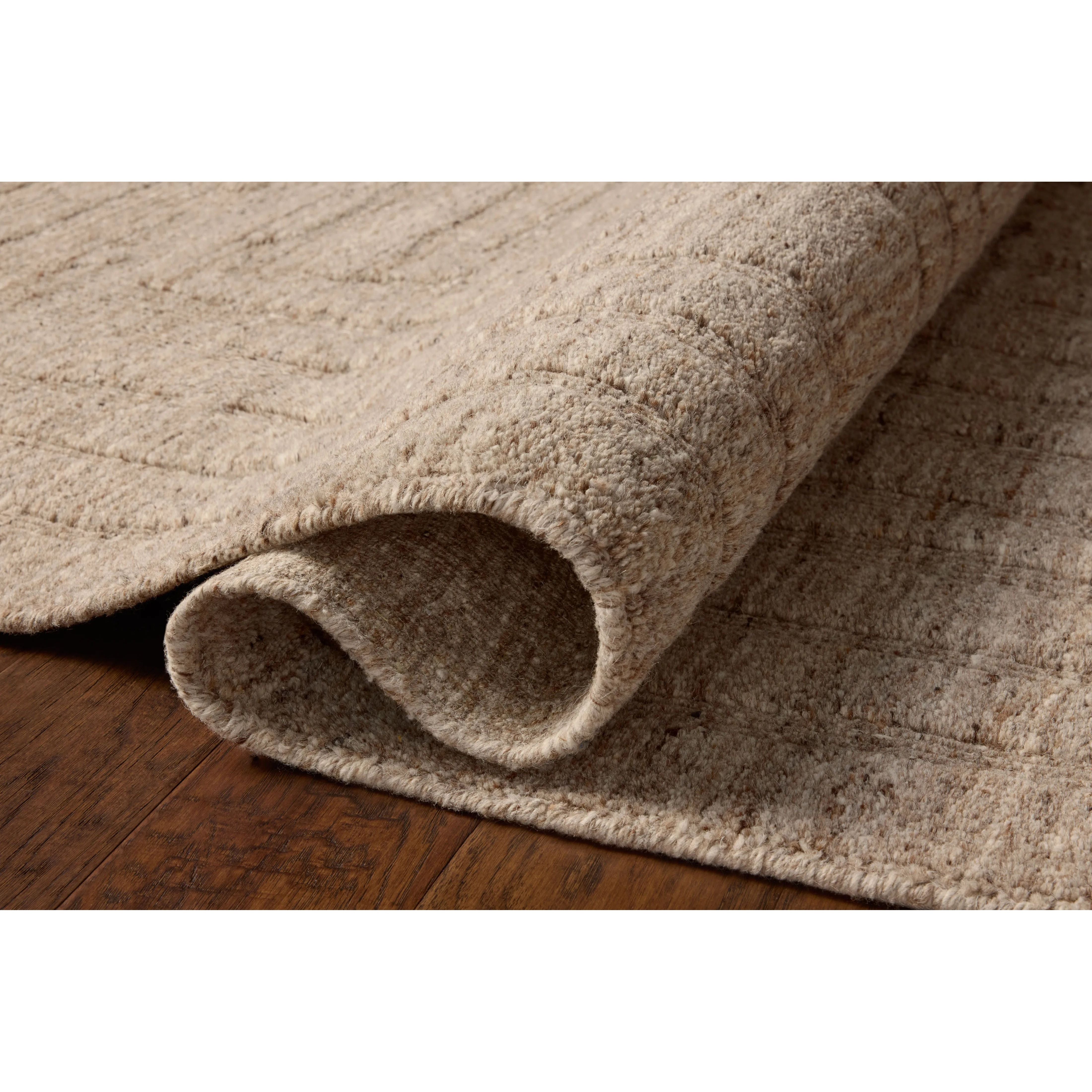 The Maren Collection is a unique handmade area rug made with a new technique that creates a dotted texture, almost like fine embroidery, but with a substantial hand-loomed feel. The pile reveals modern geometric patterns with organic shapes and natural softness, available in light, easygoing neutrals. Amethyst Home provides interior design, new home construction design consulting, vintage area rugs, and lighting in the Omaha metro area.